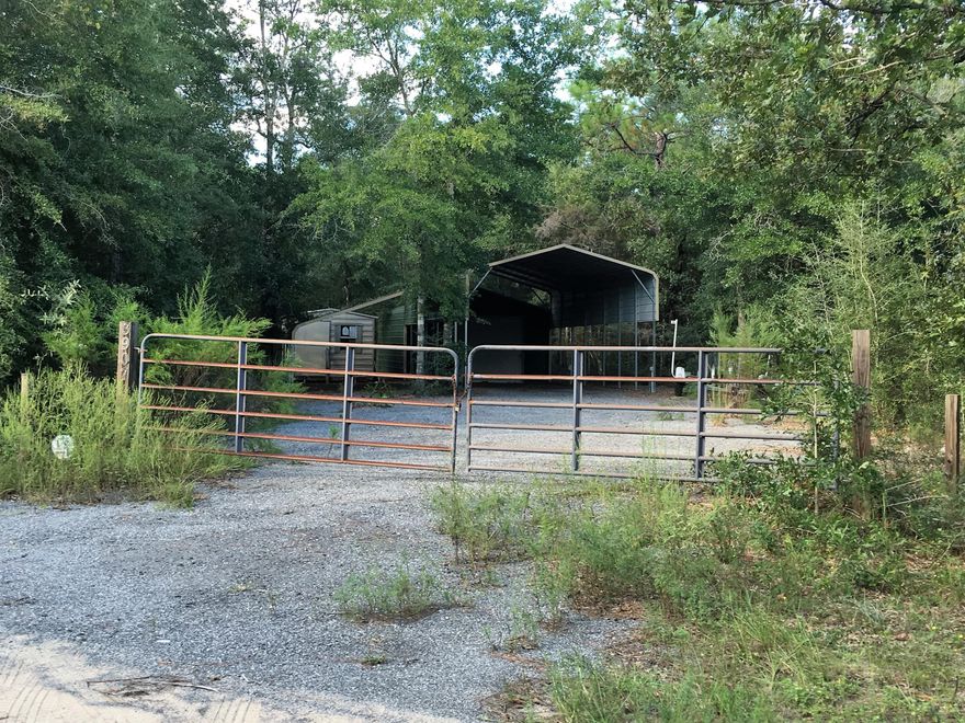 Great Piece of property on paved road with power. Property has metal garage, RV parking pad with cover, power, and side storage. Additional storage building on property. This would make a great homesite. Property has been used for recreational purposes. Seller says bring all offers