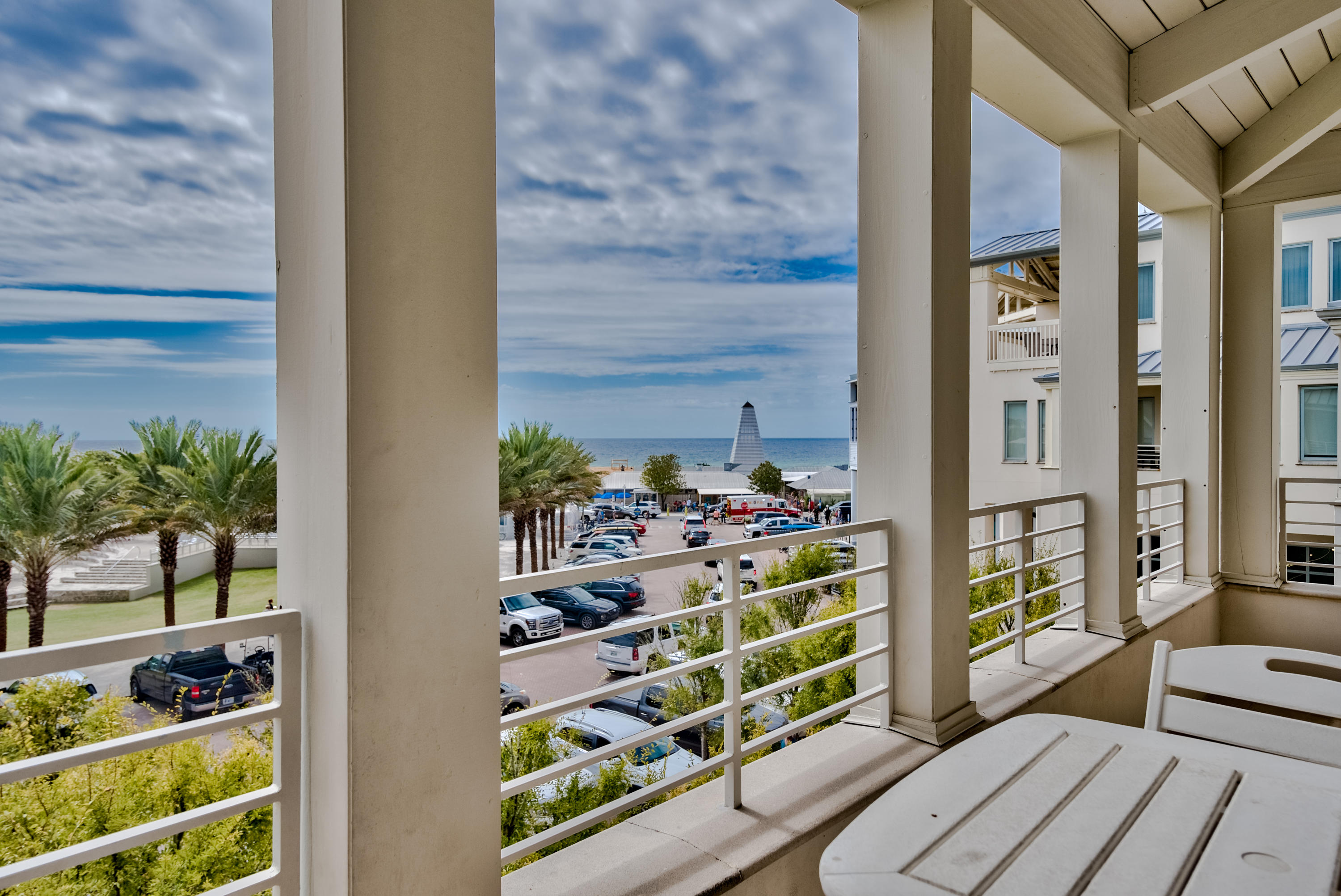 If a view of the Gulf of Mexico over the tops of palm trees is your idea of a cool beach home location, then this immaculate three bedroom, three bathroom penthouse condo might be your next residence or vacation home. Upon entering the foyer, access to the entire condo is achieved by a private elevator, or the winding French Limestone staircase. The open design is a creative blend of crisp white and stunning mahogany doors, shutters, pocket doors, cabinets and flooring with custom imported French Limestone. The living room's vaulted ceiling allows for windows on a high exterior wall and abundant natural daylight. Three sets of French doors open to a spacious covered balcony easily accommodating both dining, seating and viewing of the Seaside amphitheater and Gulf.The galley kitchen is