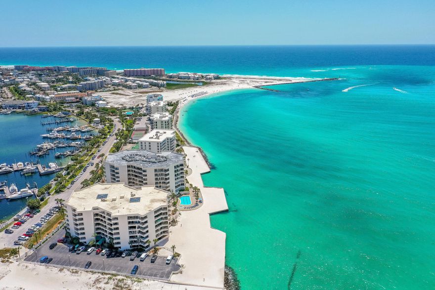 Welcome to East Pass Towers Unit 403 in the desirable area of Destin, FL! This unit offers breathtaking sunrise views of the Harbor! East Pass Towers condo overlooks the East Pass and the Gulf of Mexico and has sunsets year around! Located at the end of Holiday Isle and surrounded by the white sandy beaches of the Gulf, the unit has 2 bedrooms and 2 baths with approximately 1500 sq ft. This unit has more square footage than other 2 bedrooms units due to the added home office or bonus space! This unit is a great short term rental! The condo can also make a great primary or second home! Positioned on the 4th floor the views of the Harbor and all the gorgeous boats are magnificent! The unit has assigned parking (space 403) and an assigned storage unit. The 465 sq footage of balcony space overlooking the Harbor and with Gulf views is a rare find! Enter the unit in the heated and cooled breezeway and there is a large foyer area that also includes the home office. The living room is 30x15 sq ft and also opens to the dining room and kitchen areas. The kitchen has a raised bar that seats 4, a side by side stainless refrigerator, built in microwave, and slide in stainless and black oven/stove top. There are granite countertops and a backsplash. There is access to the balcony from the living room, dining room and guest bedroom and a private balcony from the primary bedroom. Both of the bedrooms feature king beds and the primary bedroom has a large, ensuite bathroom. East Pass Towers is a gated community with onsite security guards. Enjoy the pool and hot tub overlooking the East Pass, white sand, and emerald waters. Rent a boat to visit Crab Island. Take a boat to dinner on the Destin Harbor! There is a water tax to take you across to the Harbor Walk. This unit is a great investment and immaculately maintained! Owners are allowed to have pets at East Pass Towers. Buyer to verify all dimensions and information. 

