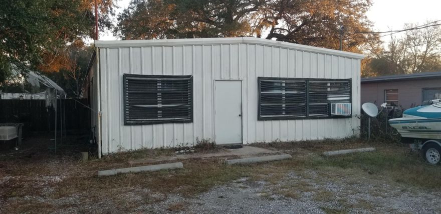 Warehouse with small office and several garage doors.
