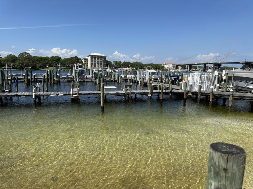 This coastal 2 Br./ 2 Ba. with easy ground floor access is in high demand.  Commodores Landing located on Okaloosa Island, a land lease, is a sound front property with a pool, dock, and boat slips which can be rented to owners on a first come, first serve basis. It is conveniently located just blocks from a county beach access, dining, mini golf, and beach stores.  This condo features tile floors throughout and a breakfast bar between the kitchen and living area.  Sliding glass doors from your living room and master bedroom lead out onto your covered back porch with an outside locked storage closet.  His and hers closets in the master bedroom.   Includes stacked washer & dryer.  Short-term rentals and pets for owners are allowed.   Perfect for a primary, secondary or vacation rental home.