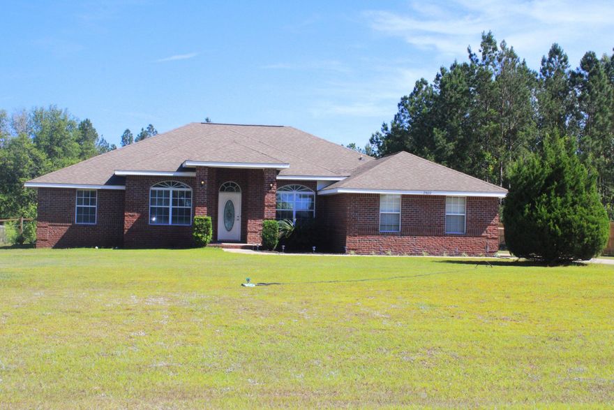 1 ACRE LOT IN PACE!  Fully cleared with fencing!  This home is located in sought-after Tamrell Forest and is ready for your move-in!  It features a host of amenities, including:  All brick exterior * 2-car Oversized Side Entry Garage, with a long driveway for plenty of extra parking * 4 Bedrooms and 3 Full Baths * 3 Separate Wings:  Master Suite wing, 2nd and 3rd Bedroom Wing with full Bathroom in between, and 3rd Guest Wing with Bedroom and Full Bathroom * Huge Covered Back Porch with access from Great Room, Back Bathroom and Master Suite, perfect for future Pool! * Rounded Inside Corners * Covered Front Porch * Spacious Great Room with 12' Vaulted Ceiling that carries into the Kitchen, Ceiling Fan, and decorative portable Fireplace * 10' High ceiling in Foyer, Formal Dining Room,  Office/Living Room * Eat-in Kitchen with newer Quartz countertop, Custom Oak Cabinets with New paint and Crown Molding, Smooth Top Self Cleaning Range, Vented Kitchen Exhaust Hood, Microwave, Refrigerator (appliances are newer, only 2 years old), Breakfast Bar, Breakfast Nook, and Corner Pantry with added built-in shelving * Separate Office, can be used as additional bedroom, formal living room, etc. *  Separate Formal Dining Room * Luxurious Master Suite features Trey Ceiling, Double Vanities, Corner Jetted Garden Tub, Acrylic Block Window for natural light, Separate Shower, Huge 8'x12' Walk-in Closet plus separate Linen Closet, and separate toilet area* Fresh interior paint * Guest bathroom has new toilet * Bathrooms have newer quartz counters and tile flooring * Cat-5 Wiring in each room * Wired for Security * Digital thermostat * Inside laundry room * Custom Mailbox * Sprinkler system zoned front yard and on Well * Roof is in good condition and was last formally inspected one year ago * BRAND NEW K-8 SCHOOL BEING BUILT AT END OF THIS ROAD!  Hurry, this one won't last!