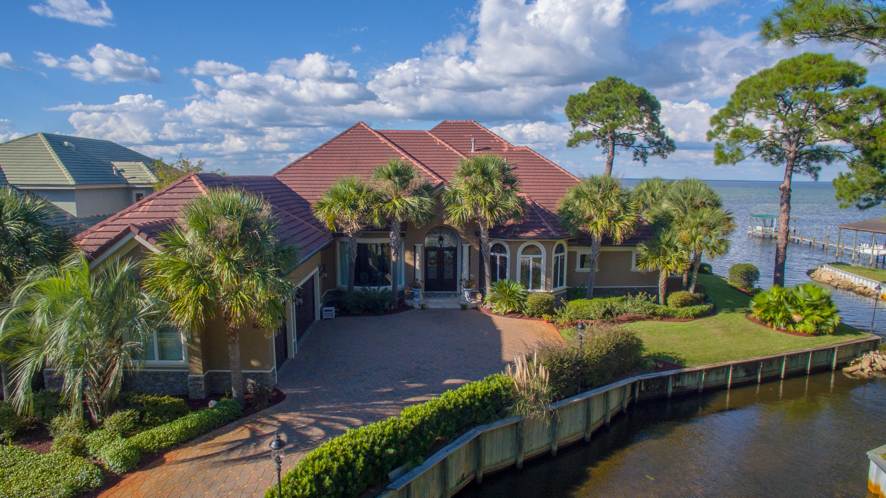 *MOTIVATED SELLER - NOW OFFERED FURNISHED* THIS EXQUISITE BAYFRONT PROPERTY IS A PREMIUM OPPORTUNITY FOR THE BUYER LOOKING FOR IMMACULATE PERFECTION! QUALITY BUILT BY DIXON KAZEK CONSTRUCTION, THIS STUNNING MEDITERRANEAN MASTERPIECE BECKONS WITH LEADED GLASS INSET DOUBLE FRONT DOORS FROM THE WINDING PAVER STONE DRIVEWAY. ONCE INSIDE THE SPACIOUS ARCHED FOYER, YOU WILL BE AMAZED BY INCREDIBLE TRAYED CEILINGS, DETAILED CROWN MOLDING, WARM FAUX FINISHES AND SEALED TRAVERTINE STONE FLOORING. DIRECTLY AHEAD IS THE FORMAL LIVING AREA, FEATURING GAS FIREPLACE AND SLIDING GLASS DOORS OPEN TO MESMERIZING POOL AND BAY VIEWS. OPPOSITE THAT IS OVERSIZED FORMAL DINING ROOM WITH UNIQUELY CURVED GLASS WINDOW AND STATELY FAUX FINISHED COLUMNS. FLANKING THIS TO THE RIGHT IS THE STUDY, RICH IN