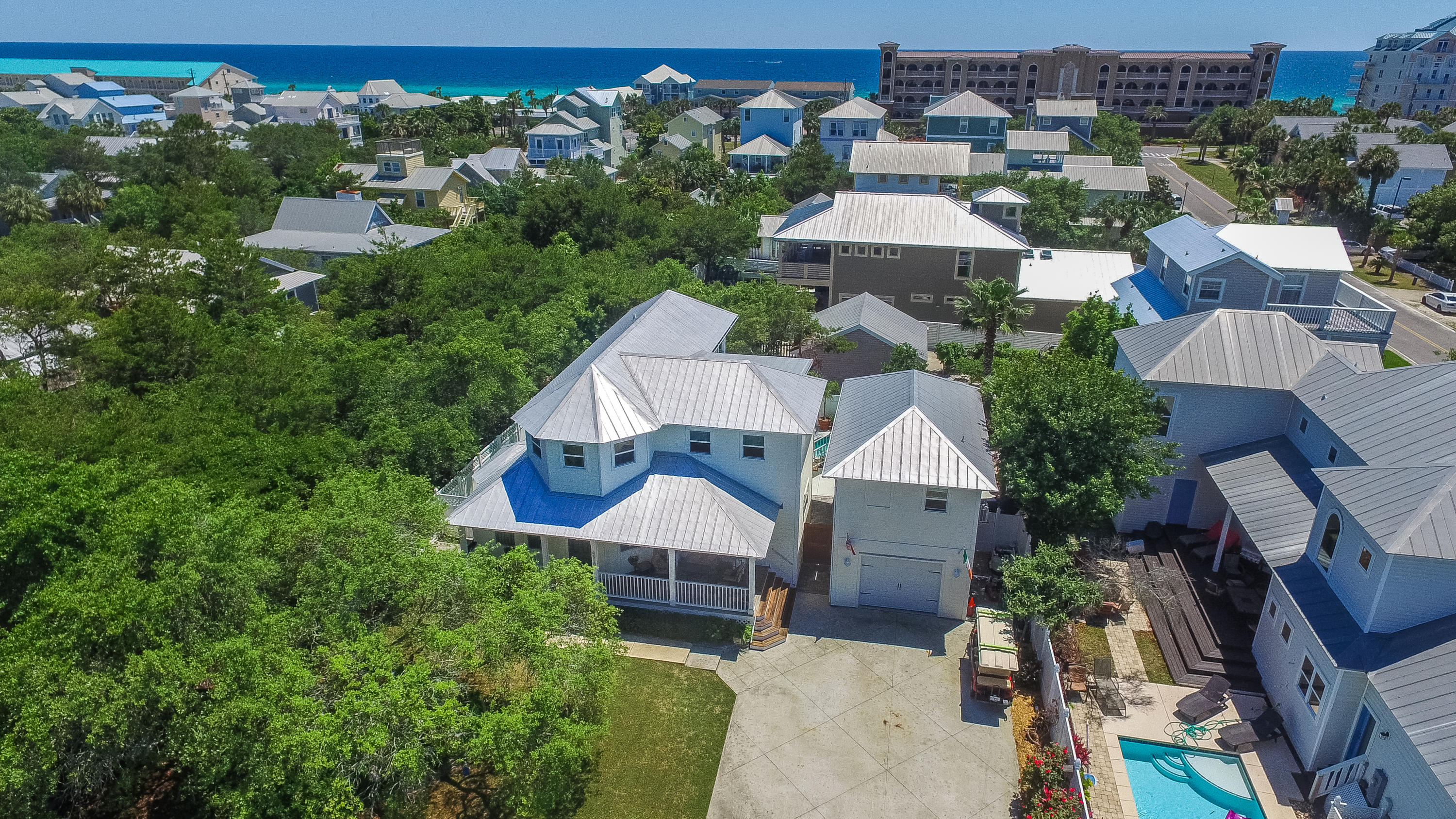 JUST REDUCED by $4,000! Brand New Hardwoods in all 1st Floor Rooms! Beautifully located property off of Hwy 98, and situated close to Gulf and Beach access. Updated in 2011, the home has great curb appeal with white picket fences, mature landscaping, beautiful Live Oaks and spacious covered sitting porch. Private backyard features an oversized pool deck, in-ground Gunite pool, outdoor shower, sitting areas and summer entertaining bar. Kitchen features Granite counter tops, hard wood cabinets, under cabinet lighting & stainless steel appliances. Master Suite features balcony overlooking pool deck, large en-suite with bath tub, oversized separate shower, dual sink vanity and upgraded tile. Carriage house built in 2010 with pine floors, kitchenette, separate A/C, balcony and updated bathroo