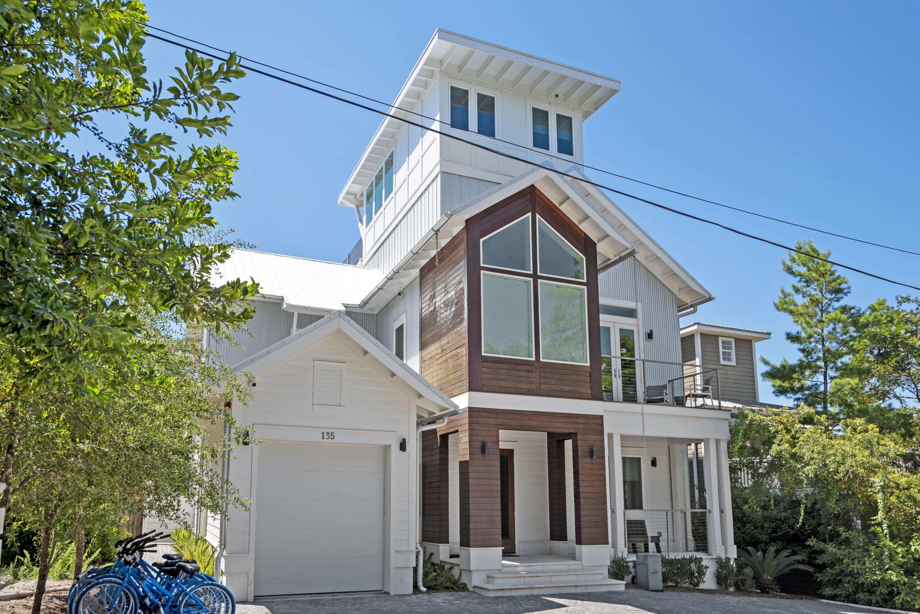 Tucked into the tree lined terrain of Old Seagrove, this incredible new build is a coastal contemporary home with incredible unique, retro, eye-catching amenities and extras and no HOA! 1st Floor offers 1 master suite and 2 additional king suites, a Game Room with sitting area kitchenette flowing to a beautiful outdoor private pool and yard. The 2nd Floor offers a second master bedroom suite and 1 additional king suite, the main living area with fireplace, a Professional Kitchen with Thermador appliances and glass accordion doors leading to the screened in balcony with outdoor dining table and cushioned sitting area Kids Floor is on the 3rd level which is accessed via spiral staircase or elevator, 2 Bunk Suites. 4th floor tower room offers a sitting area a large rooftop deck and hot tub.