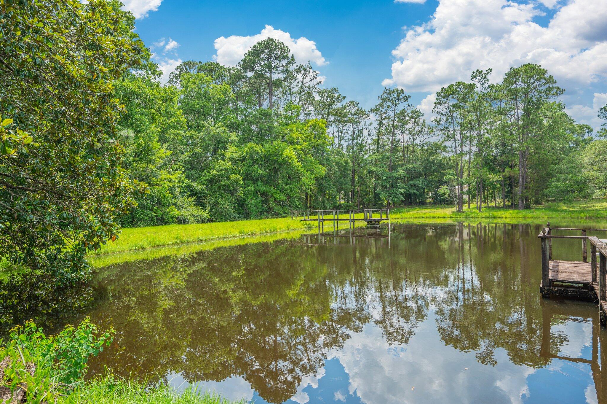 ESTATE SALE OF 14 ACRE (plus or minus) RANCHETTE with approx. 3 ACRE+- POND, directly on Hwy 90 West and just west of the New Bypass/Old Bethel Rd intersection. There are several other lakefront homesites in addition to the existing home (being conveyed strictly 'as is'). THE LAKE is absolutely swarming with bass, bream, catfish and badly needs fishing. With multiple zoning options available, POSSIBILITIES INCLUDE: Gated premium lakefront homesites, extended family complex, multi-family, wedding venue, office park, retail strip shopping, city or county park and best of all church retreat. Heads up properties like this come on the market once in a couple of generations. How can you use it next??