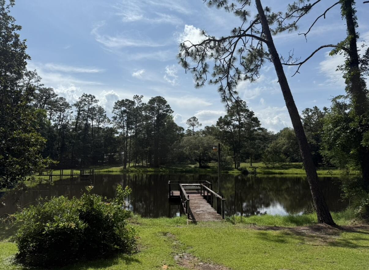 ESTATE SALE OF 14 ACRE (plus or minus) RANCHETTE with approx. 3 ACRE+- POND, directly on Hwy 90 West and just west of the New Bypass/Old Bethel Rd intersection. There are several other lakefront homesites in addition to the existing home (being conveyed strictly 'as is'). THE LAKE is absolutely swarming with bass, bream, catfish and badly needs fishing. With multiple zoning options available, POSSIBILITIES INCLUDE: Gated premium lakefront homesites, extended family complex, multi-family, wedding venue, office park, retail strip shopping, city or county park and best of all church retreat. Heads up properties like this come on the market once in a couple of generations. How can you use it next??