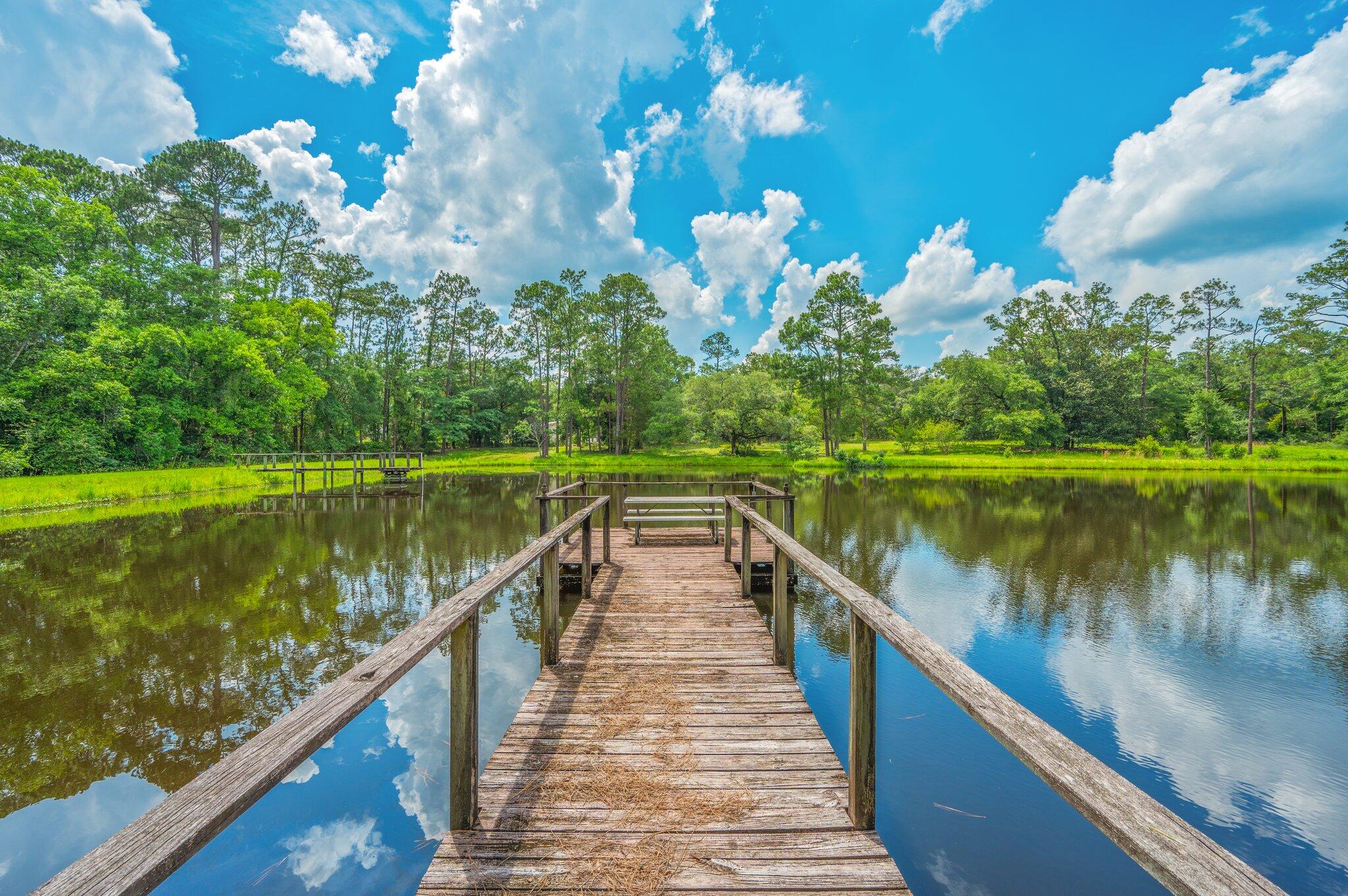 ESTATE SALE OF 14 ACRE (plus or minus) RANCHETTE with approx. 3 ACRE+- POND, directly on Hwy 90 West and just west of the New Bypass/Old Bethel Rd intersection. There are several other lakefront homesites in addition to the existing home (being conveyed strictly 'as is'). THE LAKE is absolutely swarming with bass, bream, catfish and badly needs fishing. With multiple zoning options available, POSSIBILITIES INCLUDE: Gated premium lakefront homesites, extended family complex, multi-family, wedding venue, office park, retail strip shopping, city or county park and best of all church retreat. Heads up properties like this come on the market once in a couple of generations. How can you use it next??