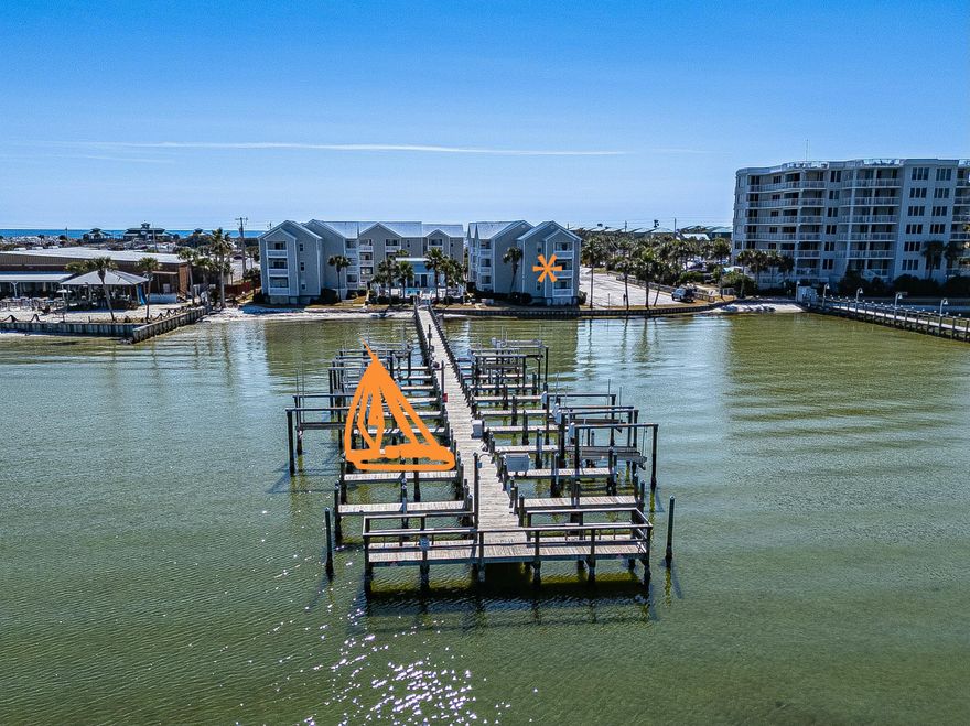 Best deal on Okaloosa Island! This END-UNIT condo with a BOAT SLIP is a rare find. Very few units in this complex have direct, stunning views overlooking Choctawhatchee Bay. Every window has a water view! Units like this are very unique and seldom hit the market. Boat slip #6 is also included, which is the third slip from the end, a very desirable position. This 2 bedroom/2 bath condo has been utilized as a primary residence for many years, but would also make a fantastic second home or lucrative short-term rental with projections up to $35,000/annually with some neighboring units doing over $51k last year! There is an assigned parking spot conveniently located next to the unit as well as a pet area. Hermitage Condominiums features a community pool, picnic area, and a dock to enjoy gorgeous sunsets and recreational fishing. Right across the road is John Beasley Park, a scenic beach park with pavilions, a snack bar, restrooms, and picnic tables to enjoy a day on the white sands and emerald waters of Okaloosa Island. BEACH ACCESS! This condo is also conveniently located down the street from top area attractions such as the Pier, Gulfarium Marine Adventure Park, The Boardwalk, Convention Center, and Wild Willy's Adventure Zone. Don't miss this opportunity. Schedule your showing today! 