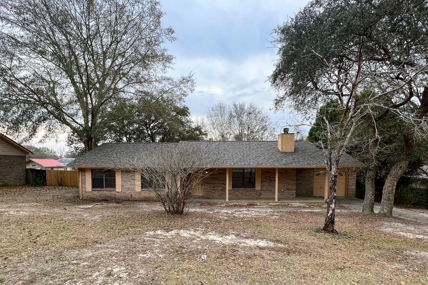 Welcome to your little piece of Crestview! **New roof installed Nov. 2021.** This home is in an established neighborhood south of I-10 and ready for new Owners or Investors to call their own. There are 3BR's and 2BA's with an expansive kitchen that has its own dining area. As you enter the living room you are greeted by lovely hardwood flooring, wood beamed ceilings, and a brick fireplace as a focal point. Head down the hallway to see the bedrooms and additional bathrooms. The primary bedroom has double closets and a private en-suite bathroom with a tub/shower combo. There is also an amazing new deck out back that was completed in January of this year that overlooks the huge fenced back yard. Don't hesitate to make your appointment to preview this one, as it won't last long in this market.