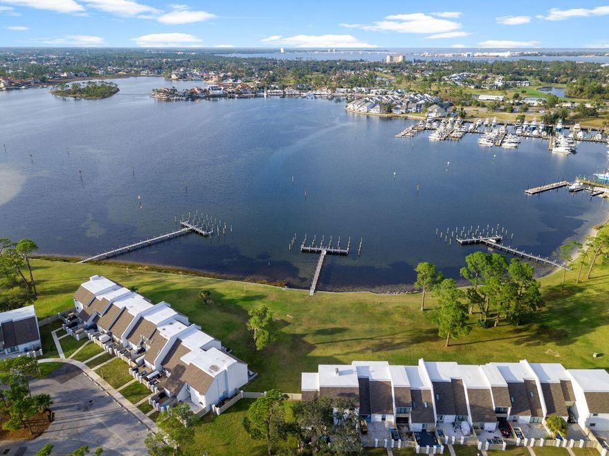 Highly sought-after WATERFRONT and for good reason! This Penthouse Turtlegrass Villa unit in Bay Point has just been completed renovated and is move-in ready. As an end unit, you'll enjoy privacy and the most perfect views of the Bay and Lagoon. Turtlegrass owners enjoy private docks in Bay Point! This is a luxury for those who wish to keep their boat behind their home for a few days at a time. Enjoy fishing from the dock or the immaculate landscaping with amazing waterfront views! This Penthouse units in Turtlegrass is designed to maximize the waterfront lifestyle views pure views from the primary suite, the guest suite and the living room. With large floor to ceiling windows, this is a luxury in waterfront!