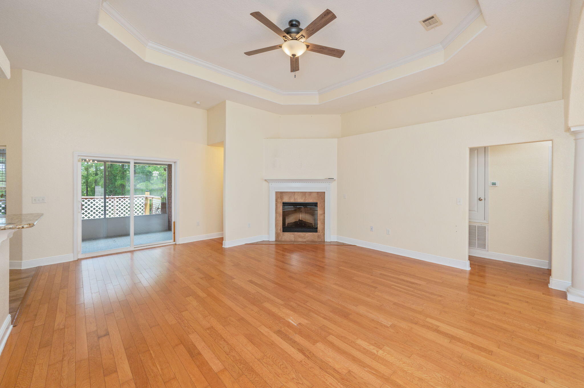 This spacious brick home screams high end, yet comfortable featuring a split floor plan, spacious living spaces, and high ceilings and ceiling fans throughout. The master bedroom is generously sized, offering plenty of room and privacy. Luxury vinyl plank flooring runs through much of the home, enhancing the bright and airy feel with hard tiles and wood in the rest- perfect for your fur babies to enjoy.The kitchen boasts granite countertops, ample cabinetry, and plenty of prep space, opening to the living area with a cozy fireplace. The two sliding glass doors lead to a large deck overlooking a large fenced backyard--perfect for relaxing or entertaining.