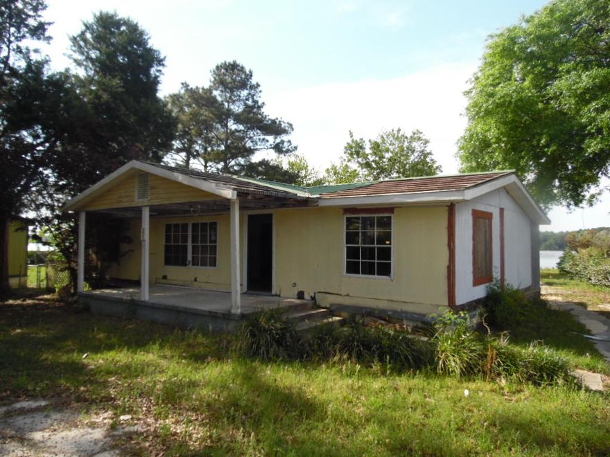 REO. WATERFRONT Home on almost half of an acre.This home has over 1500 square feet and 195 feet of waterfront on Beautiful Lake Juniper. Most of the value is placed in the land and not the home. Home is Sold ''AS IS''. SELLER FINANCING with ANY CREDIT SCORE, 10% down and proof of income.