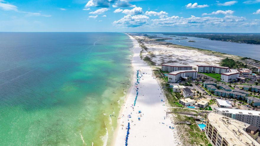 Okaloosa Island, nestled along Florida's stunning Emerald Coast, offers a peaceful retreat surrounded by the Gulf of Mexico, Choctawhatchee Bay, and the Santa Rosa Sound. From marine life encounters at the Gulfarium, to fishing at the Boardwalk Pier, and watersports or boating at the Gulf Islands National Seashore and Ross Marler Park, the area is packed with natural beauty and outdoor fun. Located directly on the Gulf, 862 Scallop Ct Unit 302 is a quiet top-floor condo offering panoramic water views and direct beach access via a private dune walkover. Inside, you'll find porcelain tile floors throughout, hurricane-rated windows and doors, and a spacious private balcony to enjoy the sea breeze. The kitchen features granite countertops, a large breakfast bar, and ample cabinet and counter space. The master bedroom includes room-darkening shades, a half-bath ensuite, and generous storage. Other upgrades include a stackable washer/dryer (new in July 2025), remote-controlled shades on the balcony doors, ceiling fans, and AC condenser coils replaced in 2024. Community amenities include a gunite pool, grill and picnic area, assigned parking plus guest spaces, and an HOA that covers high-speed internet, cable, trash, pest control, and dryer vent cleaning. Beach service is also available. Whether you're seeking a personal getaway, full-time residence, or investment property, this move-in-ready condo delivers unmatched value and true Gulf-front living on one of Florida's most beautiful islands.