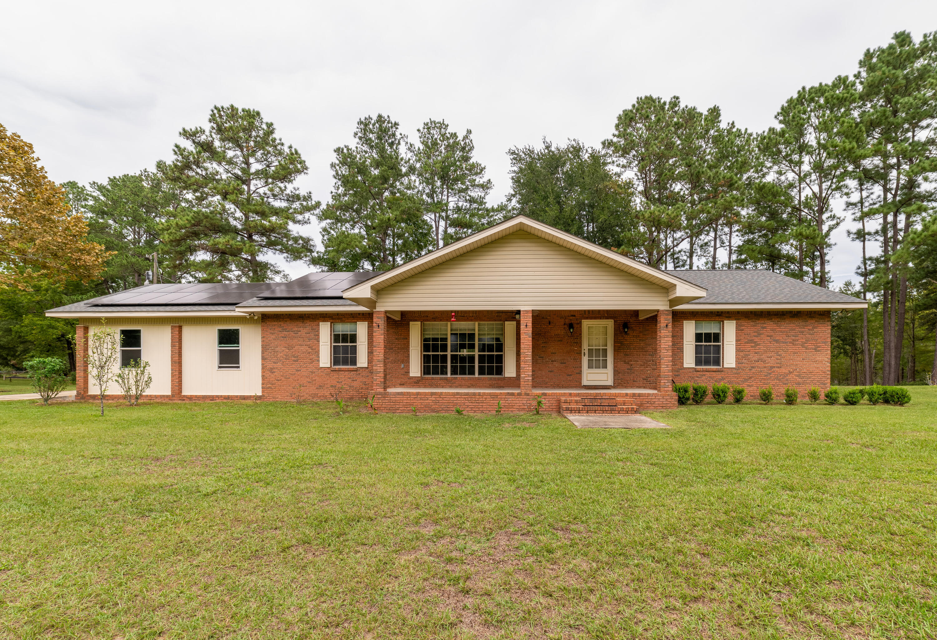 Welcome to your dream home in Caryville, Florida! This beautifully updated property offers the perfect blend of modern amenities and peaceful rural living. Nestled on a spacious natural wooded 4+ acre lot with plenty of citrus trees, the home features recently renovated interiors, including a new kitchen with appliances, fresh flooring, and upgraded bathrooms. One of the standout features of this home is its whole home generator and solar backup power system, ensuring peace of mind and energy efficiency in any situation. You'll never have to worry about power outages, making this home as practical as it is charming. Step outside to your own private oasis--a large pond, stocked with fish and home to friendly turtles. It's a serene spot perfect for fishing or simply relaxing.