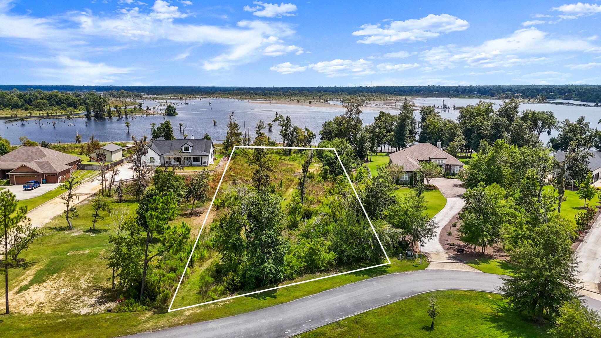 Discover this WATERFRONT opportunity to build your dream home on a 1.24-ACRE homesite in the stunning Cedar Creek community on Deer Point Lake. This expansive property with approximately 122' of water frontage offers an idyllic blend of beauty and seclusion in a community nestled within a serene wooded paradise. With approximately 122' of water frontage, this oversized property blends natural beauty, privacy, and convenience in a serene wooded community.The homesite has incredible views and mature trees remain, creating a private, shaded retreat making it a blank canvas for your dream home. Wake up in the morning to coffee overlooking the waters of Deer Point Lake on your covered back porch. Enjoy the wildlife in your back yard from the comfort of your own home.
Here, you'll have space for it all: your dream home, a pool, pole barn, detached garage, or storage for RVs, campers, and boats. With direct access to Deer Point Lake, you can enjoy fishing, kayaking, or simply watching the sunset from your own shoreline.
Cedar Creek is a thoughtfully-designed, master planned community designed to preserve its natural charm while offering resort-style amenities. Residents enjoy a large community pool & clubhouse, playground & greenspace, golf cart-friendly streets and abundant wildlife in a peaceful, country-like setting.
Known for its world-class fishing, Deer Point Lake is a haven for bream, bass, and shellcracker enthusiasts, while nearby Econfina Creek and the conveniences of Panama City dining, shopping, grocery stores, and more are just minutes away.
This is more than land, it's an opportunity to create your waterfront legacy. Wake up each morning to sparkling lake views, spend afternoons on the water, and come home to a property tailored entirely to your lifestyle.
Don't miss your chance to own one of the most desirable homesites in Cedar Creek. Eligible for 100% financing through USDA loan program.