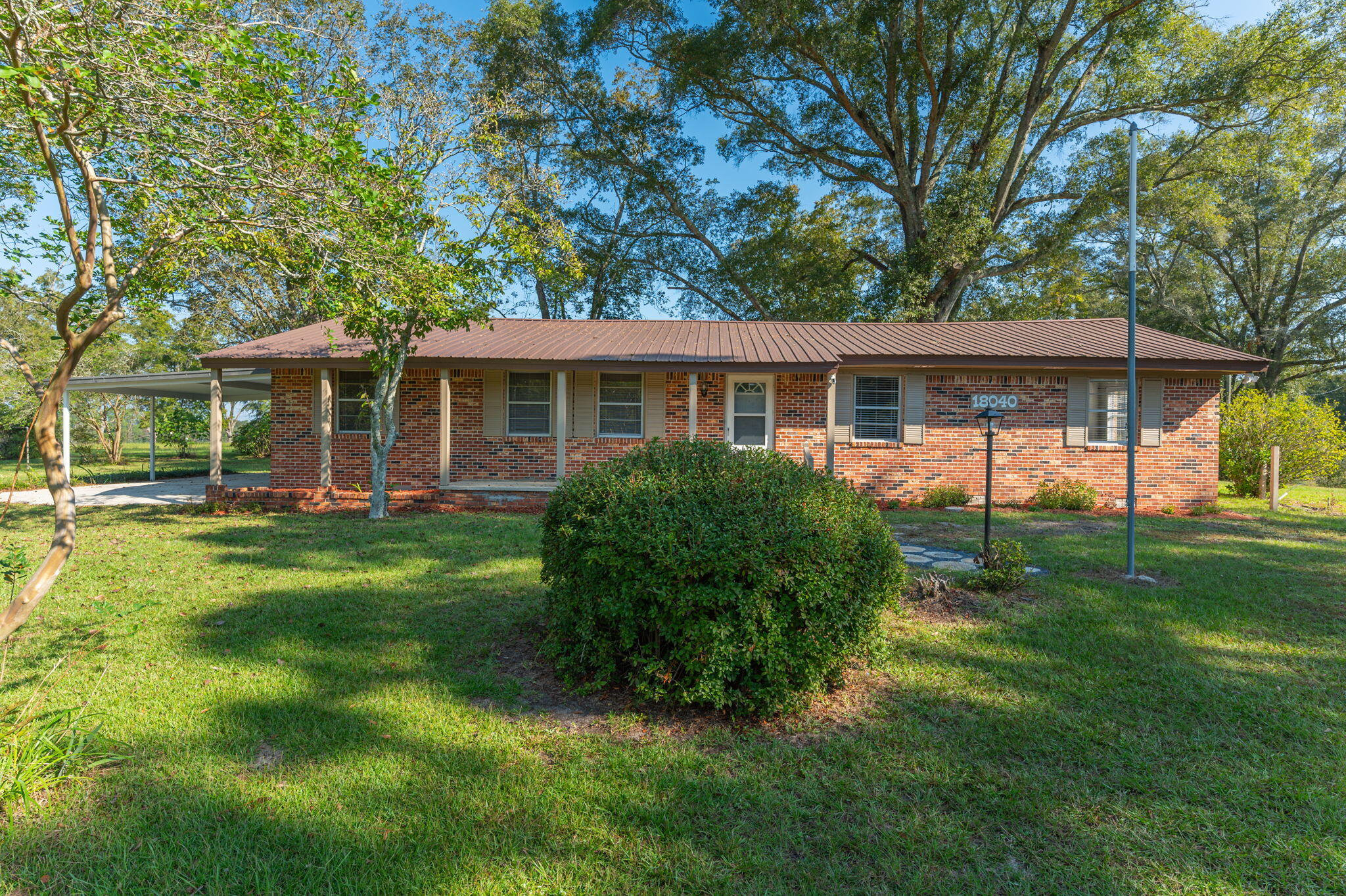 Beautiful spacious home that has been carefully maintained and updated.  Newer metal roof (approx 3 years), new HVAC unit in 2022, upgraded electrical, all new vinyl plank flooring (no carpet!!) , new interior painting, new bathroom fixtures and more. 4th bedroom used as laundry room but previously was a bedroom so has closet. Master bedroom and other bedrooms are great sizes. Open Living Room and Dining area. Kitchen is open to family room area. Kitchen includes stove, dishwasher, refrigerator and microwave with breakfast bar and solid Birch cabinets. Outside is a number of fruit trees plus 2 pecan trees.  Beautiful landscaping featuring many azalea bushes. Patio. There is also a storage building with a lean-to. Sellers are leaving all security cameras. Paxton A+ Schools.  Call today!!