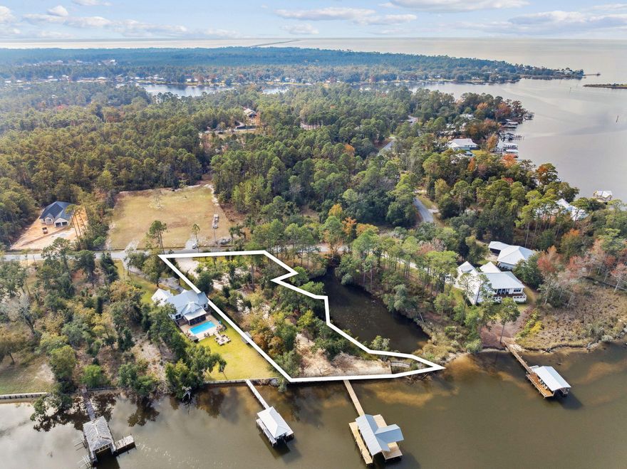Incredible 1.33-acre waterfront homesite on LaGrange Bayou featuring 195 ft of frontage, new seawall, new boathouse, and a 13,000 lb boat lift. Beautifully positioned beneath majestic oaks with sweeping bayou and lagoon views, this property includes plans for a 5,300 sq ft residence with a 3-car garage and a private pool.  Enjoy boating, jet skis, kayaking, and paddleboarding right from your backyard, with a marina and fuel dock close by. The lagoon offers natural privacy, while the bayou provides a gentle beach and traditional safe-harbor protection. A rare opportunity to build a premier coastal estate.