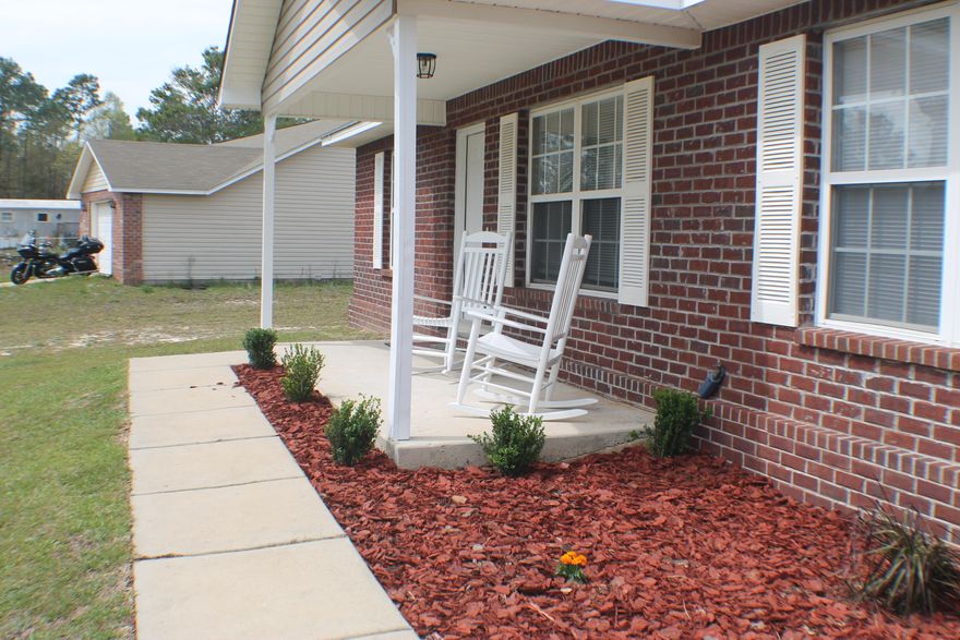 Paved road access, Beautifully remodeled with exquisite laminate flooring and new carpet! Granite counter tops, stainless appliances! Ready to move in! Bring the family and the BBQ grill! The main living area, kitchen, and hallways are all laminate with new carpet in the bedrooms. The beautiful kitchen boasts granite counter tops, tiled back splash, stainless refrigerator, dishwasher, stove and microwave hood. Check out the fine details with the stunning chandelier in the eating area and granite countertops in the bathrooms. Four bedroom 2 bath! Come home to Eagle Way today! Note the tax bill has a MSBU for road paving about $528 per year.