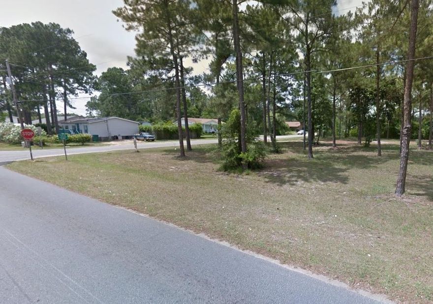 Lot Zoned R-2 Multi-Family - located in the Navarre Town Center - Place up to 4 town homes on this lot - Build your dream home today! High and dry wooded lot on paved road near shopping, beaches and schools. No build out time.