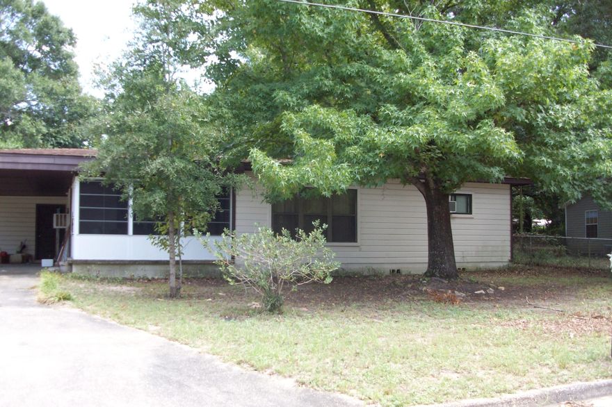 Nice older 3 bedroom 2 bath home on a level shaded lot located in a quiet established neighborhood just north of Hwy 90 in Crestview. The kitchen has solid pine cabinets, pine tongue in groove walls & ceiling, Kenmore gas range & refrigerator, double stainless sink & pantry. Dining room has wood laminate flooring & a large window A/C that cools the entire living area. The large living room is in the center of the home surrounded by the bedrooms & baths. All 3 bedrooms have window A/C units. Under all the carpeted areas is the original hardwood floors. The front porch has been converted into a sun room you can enjoy all year round. Call to see this charming home today.