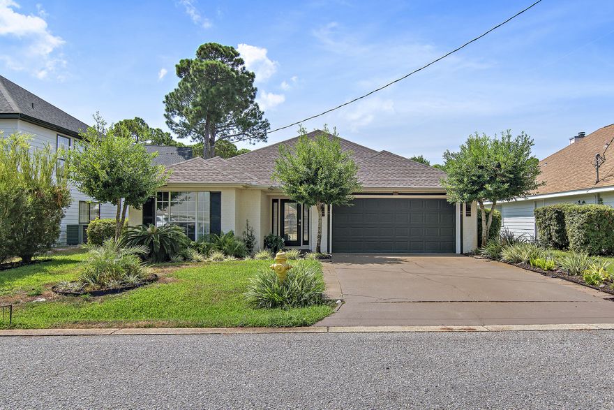 Terrific 3BR/2BA home in the middle of Miramar Beach.  Two blocks to the bay, two minutes to the beach, accessible by golf cart. Easy access to Silver Sands, Mid-Bay Bridge.  Lovely open living plan with high ceilings.  Split bedroom concept.  Master has tray ceiling, large walk-in closet, bath with garden tub and walk-in shower, twin vanities. Large LR has vaulted ceiling and a fireplace.  Full size dining room and spacious eat-in kitchen.  French doors lead out to back yard patio and neighborhood pond.  Separate laundry room (washer and dryer included).  Garage is big enough for two cars and has custom storage built-in.  Beautiful landscaping.  New 30-year roof installed 2019.
