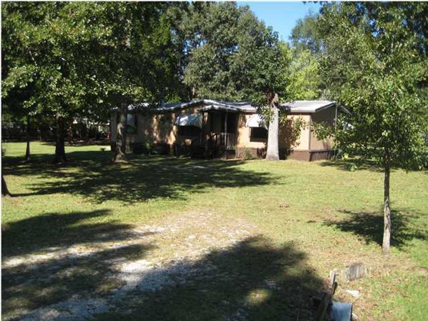 3BR/2BA home on half acre lot. Beautiful mature trees with circular driveway and located on a paved street. Work shop in back yard with storage. You need to see the large Florida room on the rear that provides an excellent recreational area for watching TV or playing area for the kids. You will also enjoy the large deck and the carport. The property is being sold ''as-is''. Possible owner-financing. There is no HOA. Great location only minutes from Black Creek and excellent fishing. Drive to the Beaches of South Walton also in a few minutes. Call now to see first hand the many features.
