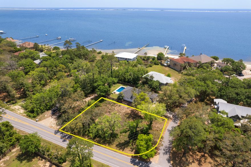 Don't miss this incredible opportunity to own a spacious, high-and-dry corner lot located at the intersection of Soundside Drive and Smokey Road. Just a short walk to the water, this property is surrounded by beautiful waterfront and interior homes in a peaceful, well-established neighborhood--with no HOA.With approximately 154 feet of frontage on Soundside Drive and 110 feet deep along Smokey Road, this lot offers plenty of space to build your dream home, garage, pool, or more. Enjoy added privacy and minimal traffic thanks to Smokey Road's quiet, dead-end setting lined with just a few waterfront residences.A previous 30-foot soil boring test and engineering report confirm the lot is well-suited for stem wall or piling construction. A survey is also available for review. Conveniently located off Hwy 98, this lot offers the perfect blend of tranquility and accessibilitymaking it one of the best available parcels on Soundside Drive.

Take a drive by to experience the charm of the neighborhoodthen reach out to schedule a private showing to walk the lot. This is a rare opportunity, and it won't last long. Contact us today to make it yours!
