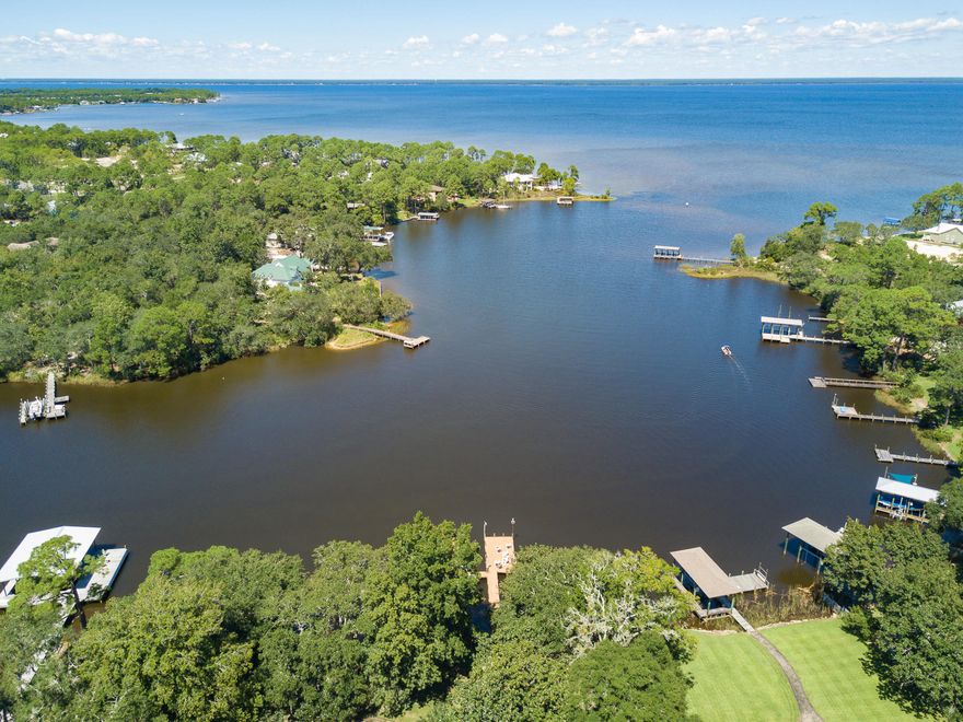 Gorgeous property offering over an acre of Bay front land in Santa Rosa Beach. Located in the exclusive neighborhood of Botany Bayou, this homesite contains 180 feet of water frontage. Property offers plenty of space to build a large estate home in a private cul-de-sac. Views of both the bay and bayou will be enjoyed from this future home and dock. Botany Bayou is located minutes from luxury dining and shopping at Grand Boulevard. Do not miss this rare opportunity. Buyer to verify all dimensions.