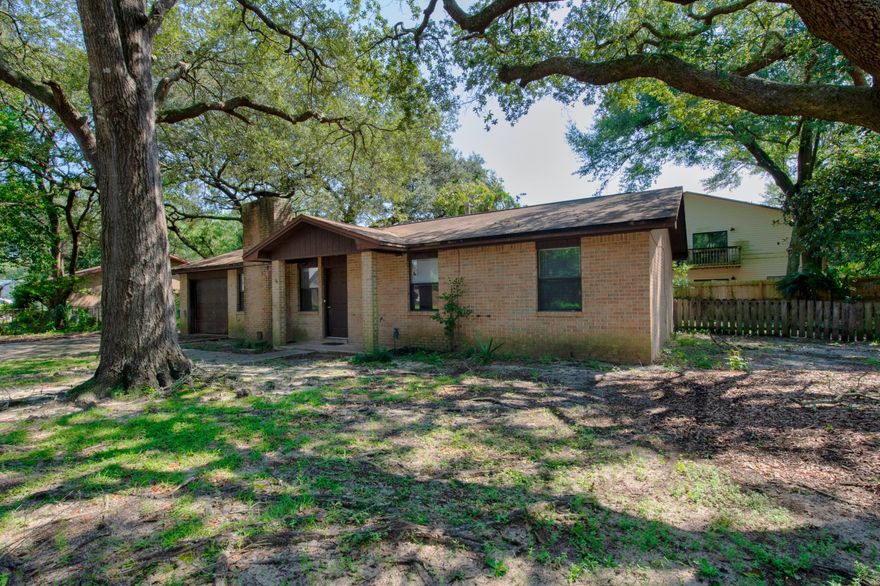 This charming patio home in the heart of Fort Walton Beach woud make a perfect starter home or investment property. Mature oak trees provide a canopy of shade over the front yard. The sizable backyard has plenty of room for pets to run and would make a perfect place to host summer barbeques. You will love the focal point of the living area- a large brick, wood burning fireplace. There is not a stitch of carpeting throughout the home for easy cleaning. With a little TLC this house will make a wonderful home. Schedule your showing today!