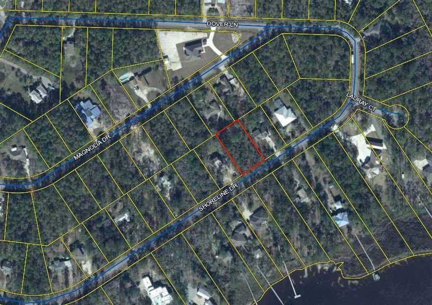 NO HOA-- Survey available, .51 acre lot is wooded with beautiful trees and across the street from the bayou. This lot has 110 feet frontage on Shoreline Drive and 200 feet deep in the LaGrange Shores Subdivision. Single access entry off of E Bay Loop Rd. (CR 83A). Water / SewerTap fees are $9983.55 per City of Freeport. Electricity available - application fee of $150.