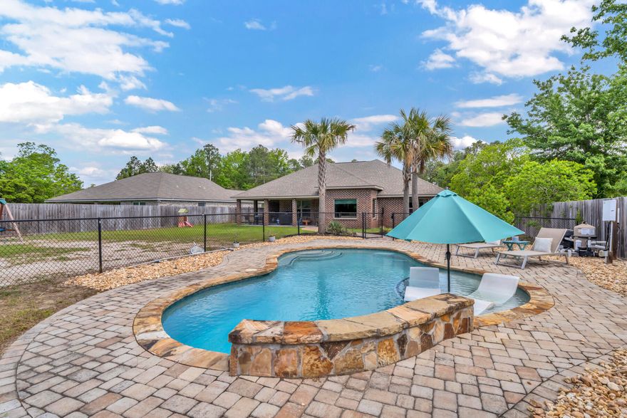 Step into your sanctuary of modern comforts and serenity with this stunning 4-bedroom, 2-bathroom, 2-car garage home with 1850 sq ft of pure luxury. Built in 2018, with its own privacy fence this pristine residence sits on half an acre to provide plenty of space for all of you outdoor living needs and wants. As you enter, you are greeted by the inviting ambiance that flows seamlessly throughout the house. The spacious layout allows for effortless movement, ensuring that every corner is a perfect blend of style and functionality. With a split floor plan and semi-open concept the mix of contemporary elegance and cozy charm, creating a welcoming atmosphere that you will love coming home to. The heart of this home is the kitchen, a culinary paradise that will inspire your inner chef. Adorned with exquisite granite countertops and gleaming stainless steel appliances, the kitchen is a masterpiece of design and functionality. Prepare delicious meals with ease and entertain guests in style in this culinary haven that is sure to be the envy of all.

As you step outside, paradise awaits in your very own backyard. A brand new pool beckons you to take a refreshing dip or bask in the sun on the tanning deck. The loungers chairs offer a perfect spot for relaxation and unwinding after a long day. Whether you're hosting a summer soiree or just enjoying a quiet moment of solitude, the outdoor space is a true haven for relaxation and entertainment.

Location is key, and this home does not disappoint. Less than 4 miles from the stunning clear waters and white sands of Navarre beach, you'll have endless opportunities to soak up the sun, feel the sand between your toes, and enjoy the tranquil waters of the Gulf. For our military residents, the base is just a short 10-mile drive away, making your commute a breeze. When it's time to indulge in some retail therapy or savor a delicious meal, you'll find yourself less than 4 miles from a variety of shopping and dining options, ensuring that every convenience is within reach.

In this home, every detail has been carefully curated to offer you the ultimate in comfort, luxury, and convenience. From the moment you step in, you will be embraced by a sense of calm and contentment, knowing that you have found your perfect retreat. Don't miss this opportunity to make this like-new home your own and experience a lifestyle of unparalleled bliss and sophistication. Welcome to your new oasis of tranquility and luxury.