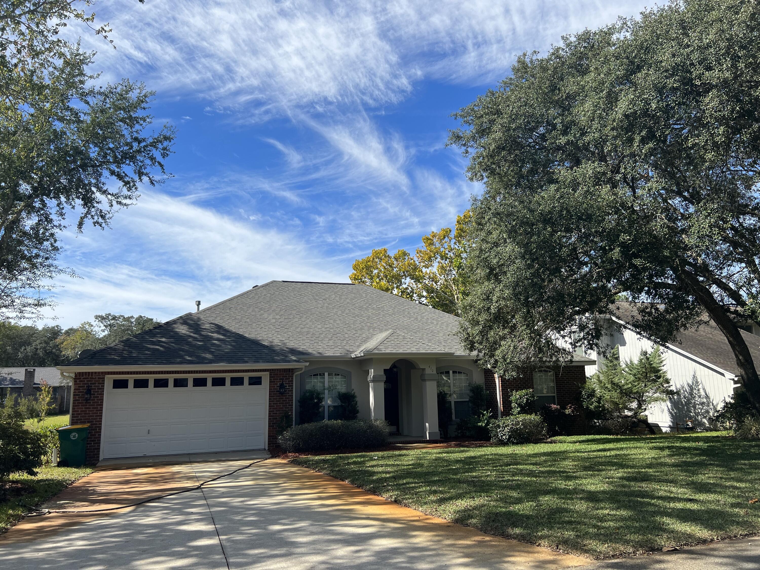 4 bedroom, 2 bath custom Bluewater Bay home overlooking the lake conveniently quick access to the Mid Bay bridge/Destin, shopping, Eglin AFB and A+ schools. Enjoy the breeze and water views from the large 316 sqft screened porch spanning the back length of the home. Interior hardwood plus 18'' tile flooring with carpeted bedrooms. The front door has a keypad/touch entry and the entrance hall opens to spacious family room with gas fireplace, vaulted-tray ceilings, crown molding and recessed lighting. The open plan great room borders an eat in kitchen with a breakfast bar and the large master bedroom features a walk-in closet and an adjoining master bathroom with double sink vanity, separate shower and whirlpool tub.  *Noteworthy Updates*Frig (Nov 2021)Stove /Range (Nov 2021)Washer (2019)