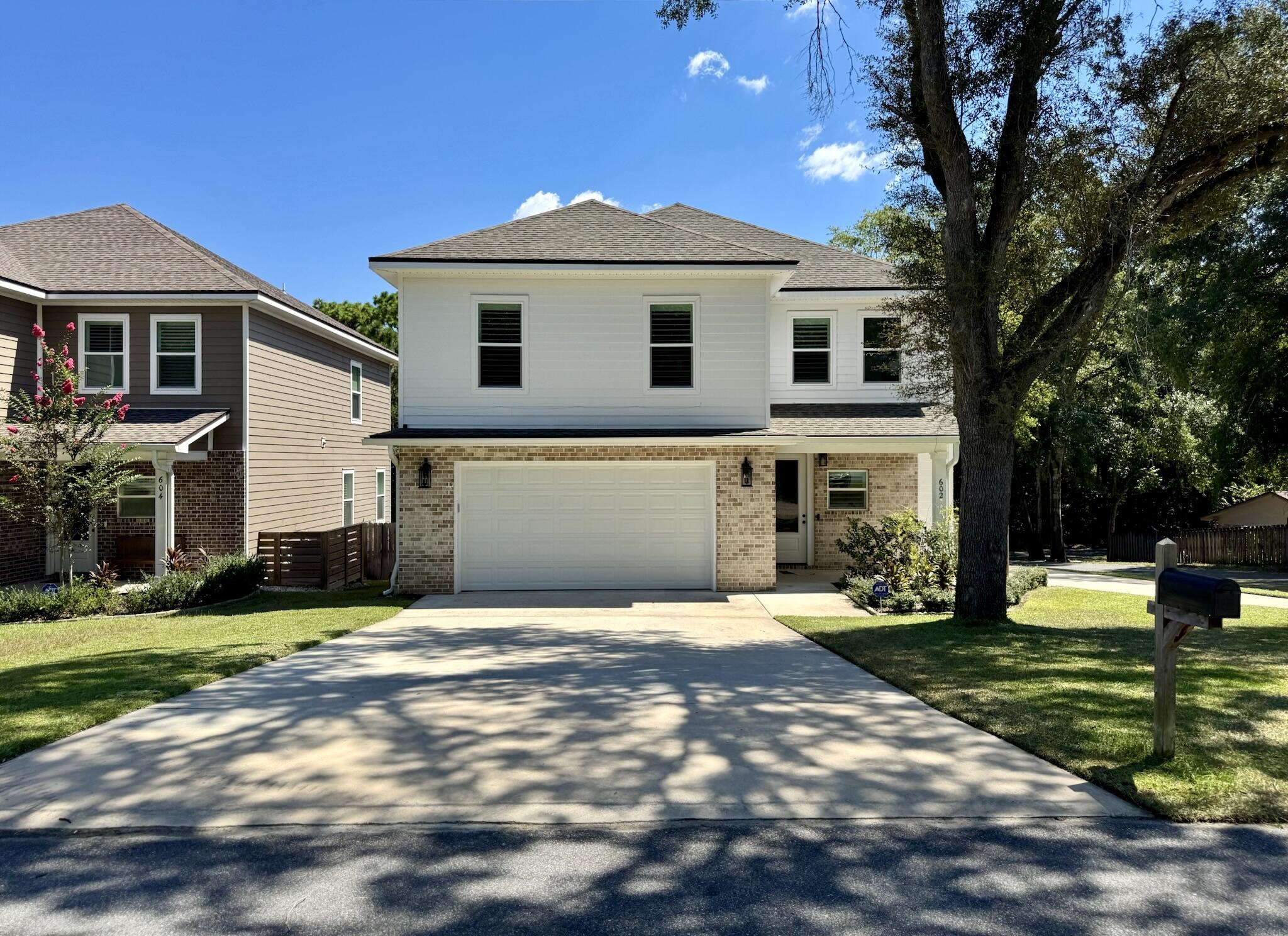 Welcome to this nearly new, beautifully appointed two-story home located in the heart of Niceville. Built in 2023, this 4-bedroom, 2.5-bath residence offers approximately 2,630 square feet of thoughtfully designed living space on a private corner lot. The spacious open floor plan features soaring 9-foot ceilings, creating a seamless flow between the living, dining, and kitchen areas. The chef's kitchen is highlighted by custom white cabinetry, quartz countertops, walk-in pantry, and soft-close drawers, making it ideal for both everyday living and entertaining. The elegant master suite provides a true retreat with a spa-like bath that includes a custom tile shower with rain-head and bench sprayer, soaking tub, and a walk-in closet with custom shelving. Every bedroom in the home offers large closets, giving abundant storage throughout. The inside laundry room is exceptionally spacious, providing the perfect combination of convenience and functionality. High-quality finishes are found throughout the home, including luxury vinyl plank flooring, crown molding, recessed lighting, and upgraded spray foam insulation. Additional efficiency features such as upgraded Nest thermostats, tankless water heater, double-pane windows, and a high-efficiency HVAC system ensure year-round comfort. Every window in the home is fitted with attractive coastal shutters, offering timeless curb appeal. The property is situated on a dead-end street, providing exceptional privacy with minimal traffic. The exterior is designed for low maintenance with a brick front and durable PVC siding, while the covered porch and deck provide inviting outdoor living spaces. An oversized two-car garage and an additional side driveway provide plenty of parking and flexibility for guests, boats, or recreational vehicles.This home also benefits from its prime location near some of the area's best recreation. Rocky Bayou Country Club and the Golf Club at Bluewater Bay are just minutes away, offering championship golf in beautiful settings. Families will appreciate the proximity to community parks, playgrounds, and walking trails that enhance the active Niceville lifestyle. Conveniently located near top-rated schools, shopping, and other amenities, the property is zoned for Lula J. Edge Elementary, C. W. Ruckel Middle, and Niceville Senior High.