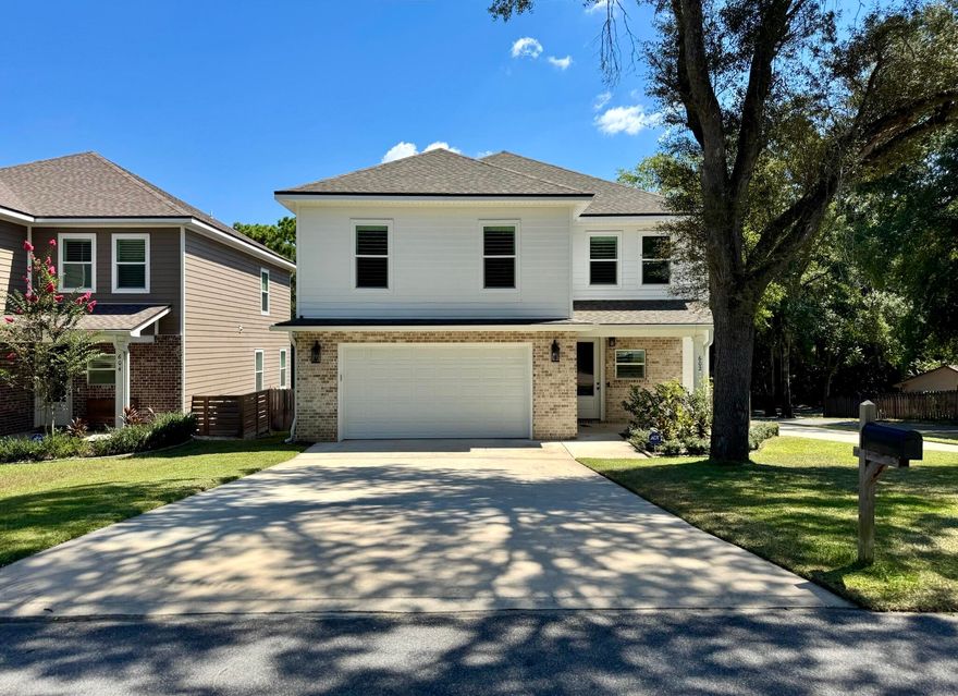 Welcome to this nearly new, beautifully appointed two-story home located in the heart of Niceville. Built in 2023, this 4-bedroom, 2.5-bath residence offers approximately 2,630 square feet of thoughtfully designed living space on a private corner lot. The spacious open floor plan features soaring 9-foot ceilings, creating a seamless flow between the living, dining, and kitchen areas. The chef's kitchen is highlighted by custom white cabinetry, quartz countertops, walk-in pantry, and soft-close drawers, making it ideal for both everyday living and entertaining. The elegant master suite provides a true retreat with a spa-like bath that includes a custom tile shower with rain-head and bench sprayer, soaking tub, and a walk-in closet with custom shelving. Every bedroom in the home offers large closets, giving abundant storage throughout. The inside laundry room is exceptionally spacious, providing the perfect combination of convenience and functionality. High-quality finishes are found throughout the home, including luxury vinyl plank flooring, crown molding, recessed lighting, and upgraded spray foam insulation. Additional efficiency features such as upgraded Nest thermostats, tankless water heater, double-pane windows, and a high-efficiency HVAC system ensure year-round comfort. Every window in the home is fitted with attractive coastal shutters, offering timeless curb appeal. The property is situated on a dead-end street, providing exceptional privacy with minimal traffic. The exterior is designed for low maintenance with a brick front and durable PVC siding, while the covered porch and deck provide inviting outdoor living spaces. An oversized two-car garage and an additional side driveway provide plenty of parking and flexibility for guests, boats, or recreational vehicles.This home also benefits from its prime location near some of the area's best recreation. Rocky Bayou Country Club and the Golf Club at Bluewater Bay are just minutes away, offering championship golf in beautiful settings. Families will appreciate the proximity to community parks, playgrounds, and walking trails that enhance the active Niceville lifestyle. Conveniently located near top-rated schools, shopping, and other amenities, the property is zoned for Lula J. Edge Elementary, C. W. Ruckel Middle, and Niceville Senior High.