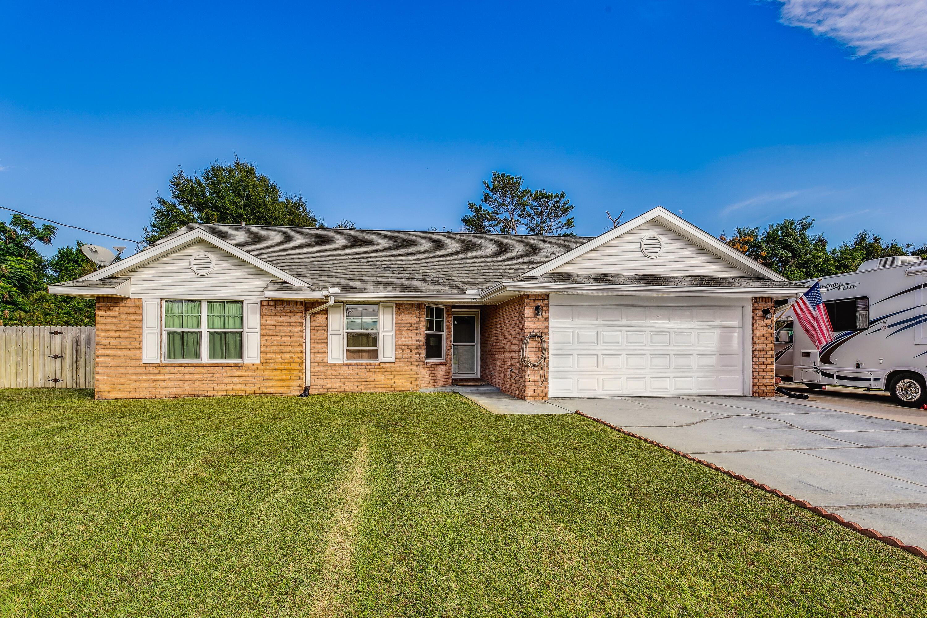 Don't miss out on this immaculately maintained 4 sided brick ranch with brand new carpet, new interior paint throughout, new hurricane rated impact glass windows, and new HVAC. Features include a huge living room with soaring ceilings and cozy fireplace, well appointed kitchen with upgraded countertops, cabinets with soft close featur and eat in dining area, owners suite with double closet, spa like master bath, jetted tub and separate shower. Outside you'll find an oversized screened patio leading to the private fenced backyard as well as an extended parking pad perfect for RV or boat parking!