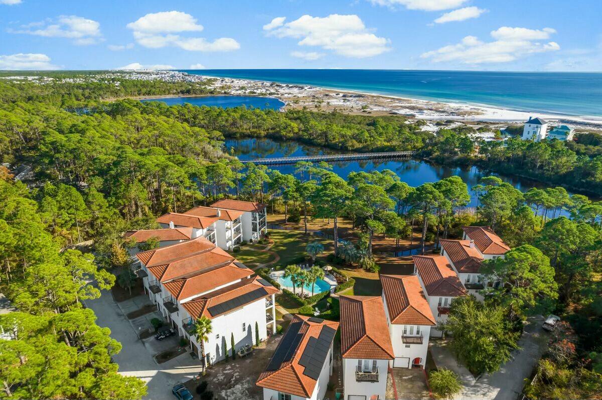 Discover your perfect home at 68 Mar-A-Lago, a stunning Mediterranean-style residence that beautifully blends tranquility with convenience. This inviting property features elegant quartz countertops, stainless steel appliances, and hardwood flooring throughout. The open-concept first floor seamlessly connects the kitchen, living room, and outdoor balcony, creating an ideal space for family gatherings and entertaining. On the third floor, the primary bedroom offers breathtaking views of the lake and gulf, complete with a private porch perfect for enjoying your morning coffee. With ample parking provided by a garage and driveway, you'll never have to worry about space. Located in a private community with access to a pool and just a short stroll from public beach access, this home is surrounded by natural beauty and recreational opportunities. With its excellent rental potential, this property is perfect for those seeking a long-term residence in a serene setting. Don't miss out on this incredible opportunity!