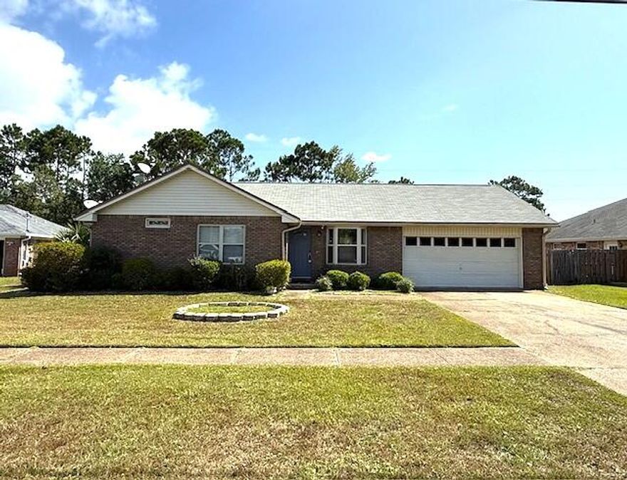 Nestled within the Fox Den Villages subdivision, is this great 3 bedroom, 2 bathroom home boasts a 2 car garage and convenient location and by the stunning Navarre Beach. The interior has been freshly painted, and the expansive living room features an remote control electric fireplace. The kitchen features soft-close cabinets and the appliances will remain. A lovely Florida Room offers a serene space for plants and guest to enjoy. Large YARD with privacy fence and electric hookup that was used for an above ground pool.  **Hurlburt Base just about 9 miles away**  HOME WARRANTY INCLUDED, Water Heater 2019, Roof 2005, HVAC 2023