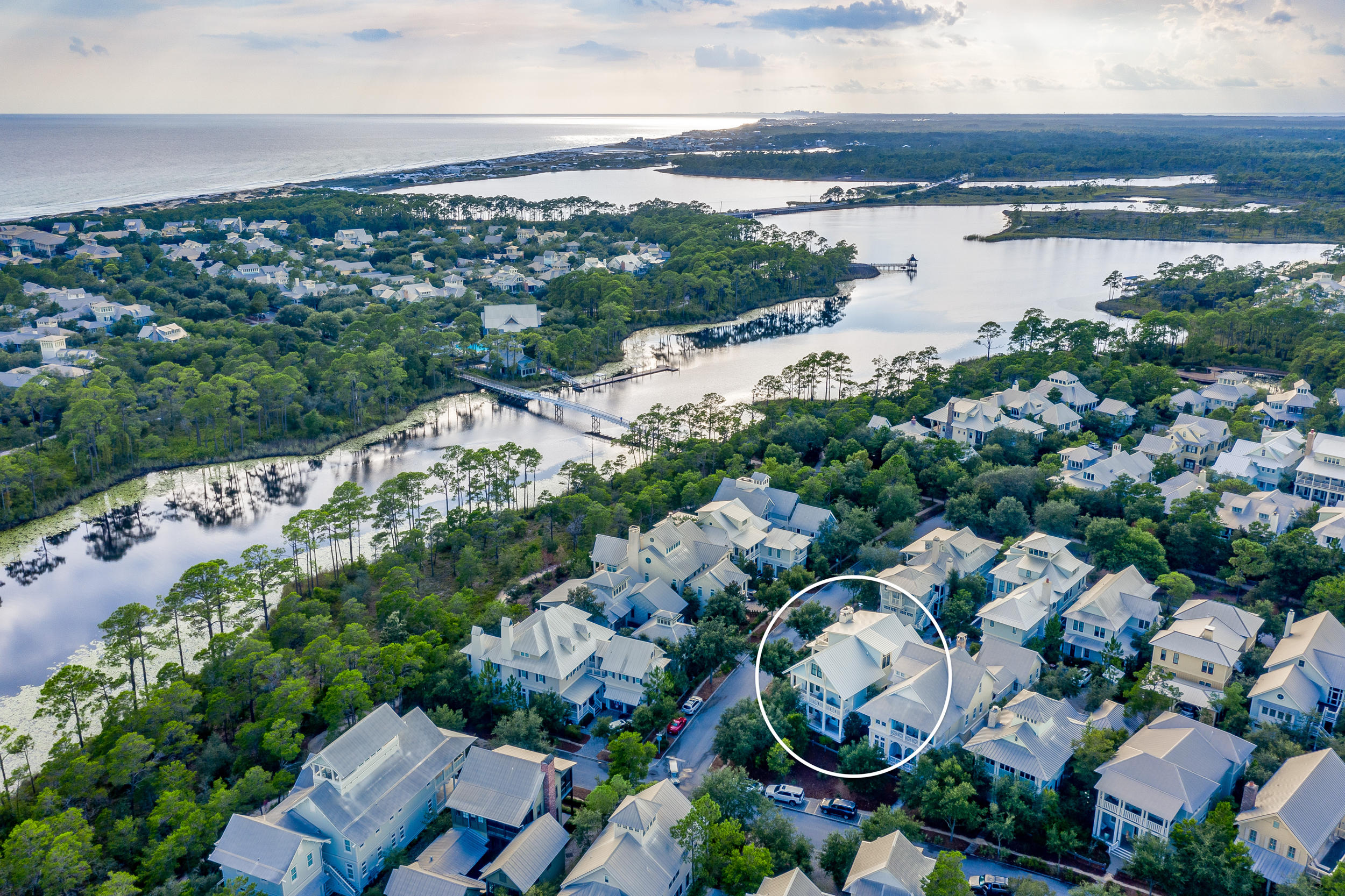 Sunlight streams through the gorgeous open spaces of this 5BR/5.5 BA WaterColor retreat conveniently located just steps from the Phase III pedestrian bridge for easy access to community amenities such as the BoatHouse, the newly expanded WaterColor Beach Club and the Phase III Frog Pool. A custom collaboration between Thurber Architecture and Barbara Jordan Interiors, crisp coastal design with soothing neutrals carries throughout the home with desirable features such as shiplap walls, warm toned hardwood floors, barn doors, designer lighting, beautiful tiled bathrooms, surround sound, Rinnai tankless water heaters and much more. The open concept living and dining area is highlighted by a lovely gas fireplace with driftwood mantle and built-in surrounds.