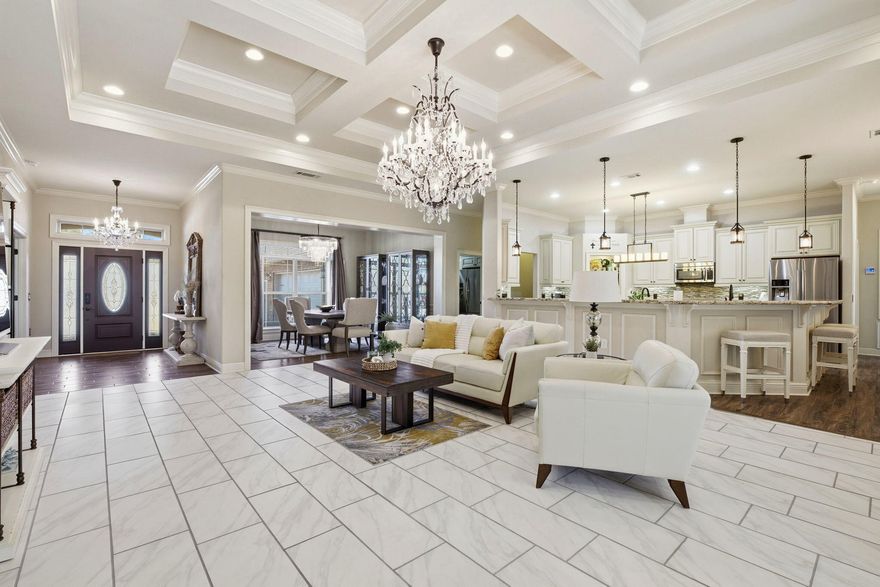 Located within a prestigious, thoughtfully planned neighborhood, this exceptional residence blends refined design with high-end upgrades and everyday functionality. From the moment you enter, the living room's coffered ceiling sets an elegant tone, complemented by high-end upgraded tile flooring that flows seamlessly throughout the home, creating a cohesive and sophisticated aesthetic.The oversized three-car garage is a true showpiece, featuring full tile flooring, custom cabinetry, striking hexagon LED lighting, and a Mitsubishi mini-split system, offering a climate-controlled space ideal for a luxury workshop, gym, or additional storage. An expansive paver driveway enhances both curb appeal and convenience. Designed for elevated indoor-outdoor living, the enclosed lanai is anchored by a gas fireplace and dedicated gas line for grilling, creating the perfect setting for entertaining or unwinding year-round. The home also includes a tankless water heater, reclaimed water irrigation system for reduced utility costs, and hurricane window protection for added peace of mind.

An unfinished, insulated bonus room over the garage, already framed for a future bathroom or closet, offers endless possibilities for expansionideal for a private guest suite, home office, or media retreat. Residents also enjoy access to a low-cost, fenced storage area for boats, trailers, or RVs, a rare amenity in luxury communities.

The neighborhood itself is designed for connection and convenience, featuring sidewalks, underground utilities, and pedestrian access leading directly to the middle school. With a very easy commute to the military base, this home delivers both prestige and practicality in a highly sought-after setting.

Thoughtfully curated with upscale finishes, premium upgrades, and future flexibility, this residence offers an exceptional lifestyle in one of the area's most desirable communities.