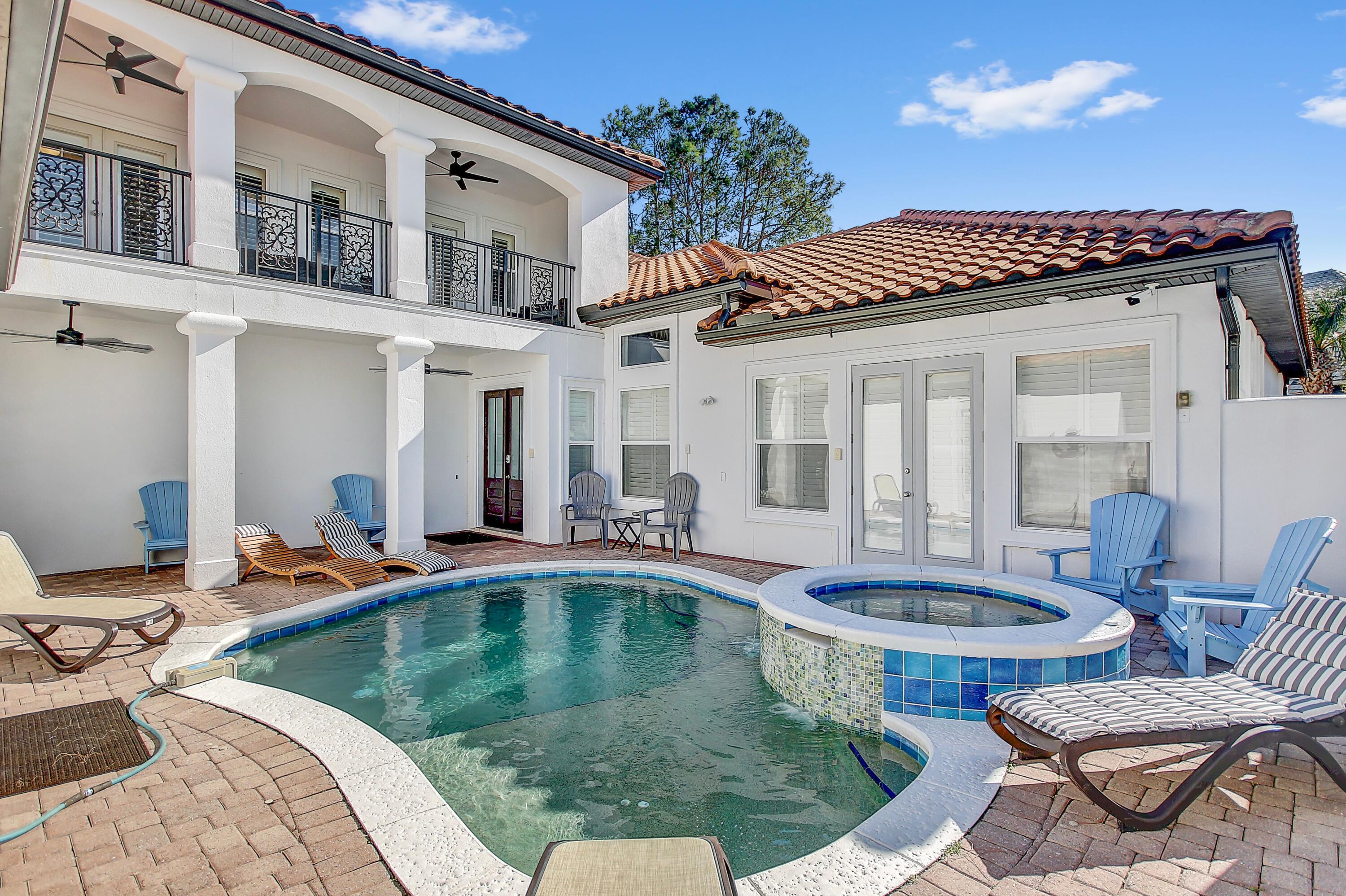 This exquisite custom home, nestled in the secure and golf cart-friendly Destiny East community, boasts a spacious layout, a detached carriage house, and a charming courtyard featuring a pool, hot tub, and outdoor kitchen. This home is ideal for a primary residence, second home, or vacation rental! The Master bedroom and carriage house bedroom are conveniently located on the ground level. The large bunk room with six beds and the fifth guest bedroom open to an oversized balcony with views of the courtyard and pool. This home is being offered fully furnished and ready to occupy or rent. A beautiful six-seat golf cart is also included. Buyer to verify all dimensions and essential information. 2 lighted tennis courts, basketball court, a large pool and hot tub, playground and grilling areas.