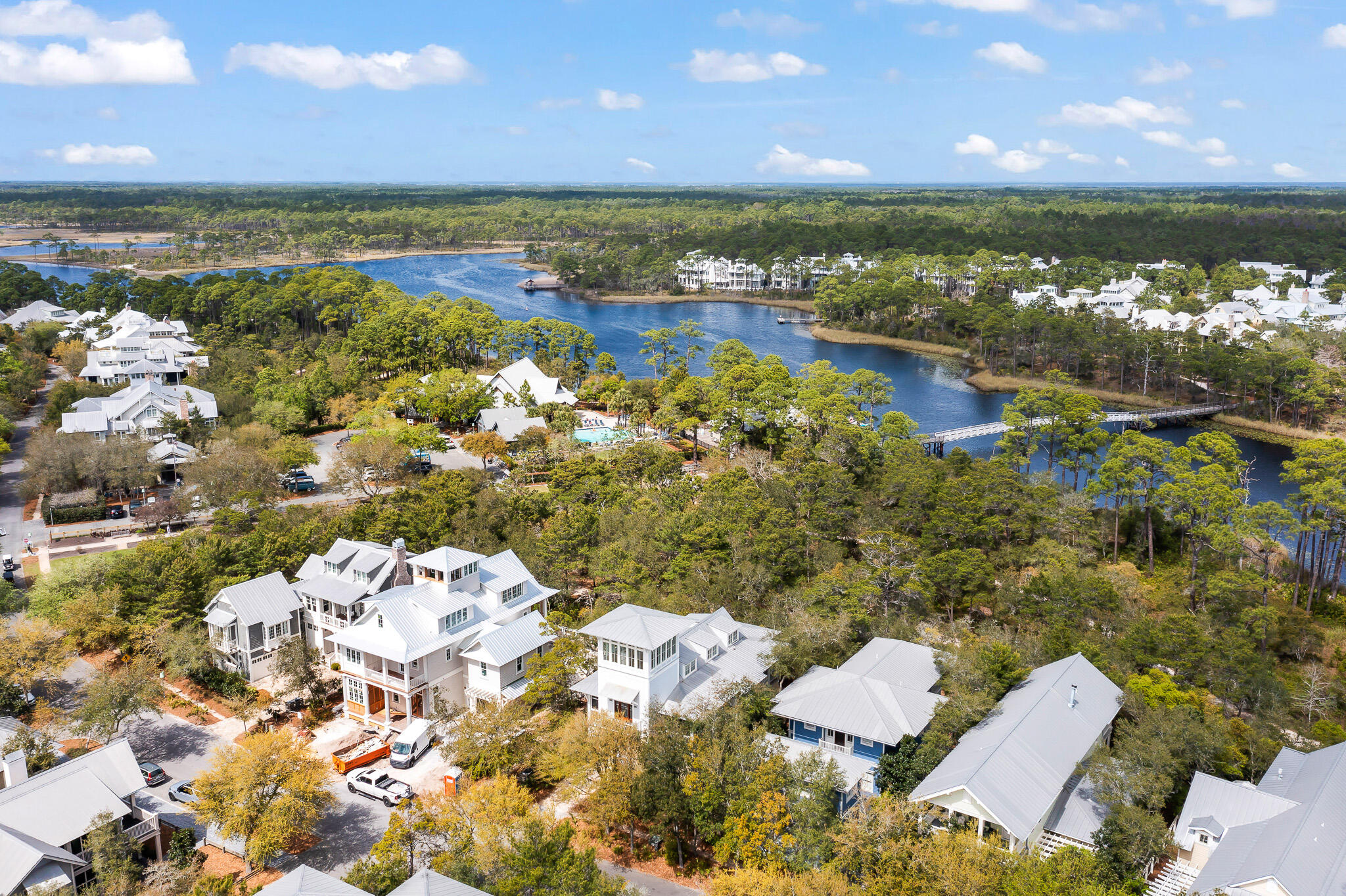 Positioned in the ideal location backing up to Western Lake in Phase I of WaterColor right by the Amphitheater and Boat House and a 2 minute bike ride or 5 minute walk to the Beach Club is this custom-built home with architecturally stunning elements throughout not commonly found in WaterColor and featuring 360 degree beautiful gulf and lake views from one of the highest tower rooms in WaterColor complete with a wet bar and ample room to relax & watch the sunsets or do yoga at sunrise.The heart of this home is the private second floor living area with vaulted wood ceilings surrounded by trees and walls of windows that flood light into the open living, kitchen, and dining space. Easily flow from the inside to the outside large screened-in