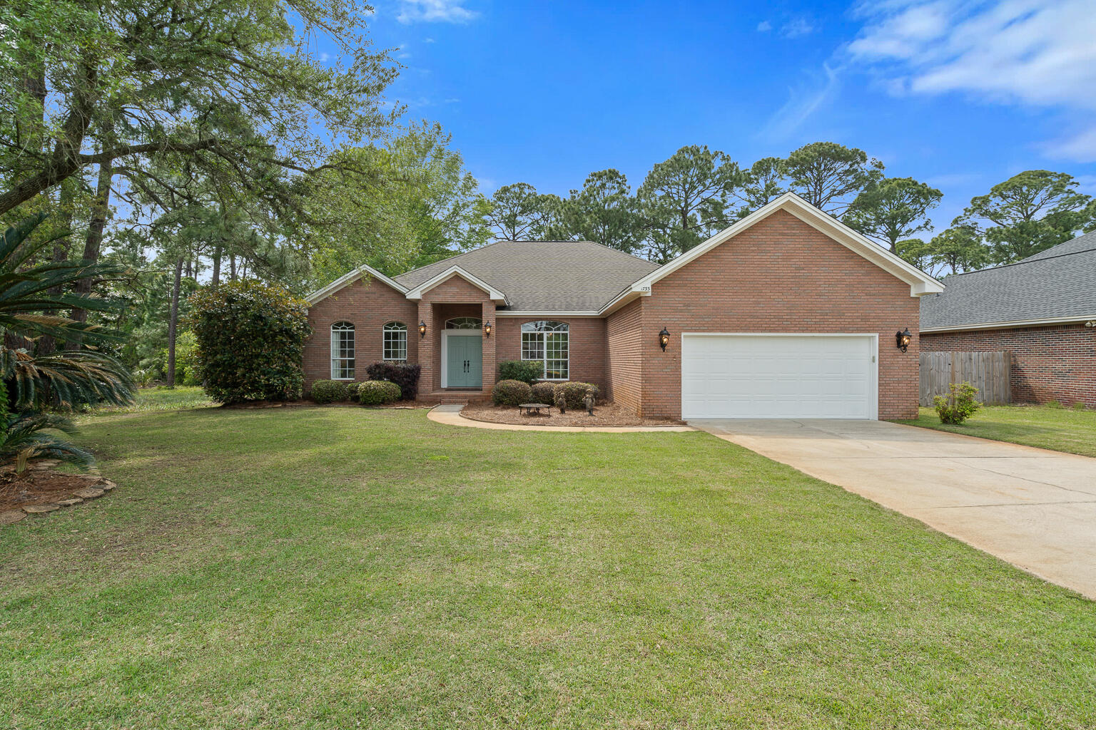 Welcome to this BEAUTIFUL brick home nestled in David's Landing in Navarre. Located less than 600 feet from the Santa Rosa Sound, backing up to a conservation parcel, and no HOA - the opportunity to own a home on this street does not come around often! This custom built 3 bedroom, 3 bathroom property features a split floor plan, formal dining space, fireplace, generous sized 2 car garage, extended covered patio, and more! The primary suite boasts a spa like ensuite, as well as a separate sitting room that offers incredible flexibility. Whether you envision a home office, nursery, reading nook, fitness area, or even a cozy TV lounge, this bonus space is ready to adapt to your lifestyle. Back through the living space to find large windows that frame the fireplace and fill the space with  natural light and offer a fantastic view of the beautifully landscaped fenced-in backyard. The kitchen features granite countertops, a pantry, breakfast nook, and plenty of cabinet and counterspace. There are 2 additional bedrooms - one with its own ensuite bathroom - and an additional full bathroom down the hall past the laundry room. Come see this beauty today, and make this your Emerald Coast Dream Home!
