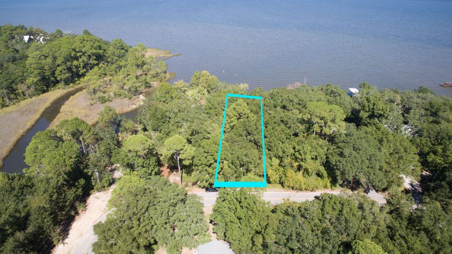 This beautiful Bay Front lot in the coveted Daughette's Subdivision is currently the best waterfront lot on the market in South Walton. Great location on a quiet, paved street covered in mature trees including oaks and magnolias. This location is only minutes away from the white sand beaches and a straight shot up Hwy 283 to the Gulf of Mexico and Grayton Beach.Measuring 75x221 this lot will accomodate almost any style house. There is no build-out time requirement and there is no homeowners association; therefore you are free to build what you want when you want. This area has public sewer and public water available, and the property is primarily located in ''Flood Zone X'', so Flood Insurance is optional if built in that zone. There is a Bulk/Head Seawall in place. Recent survey