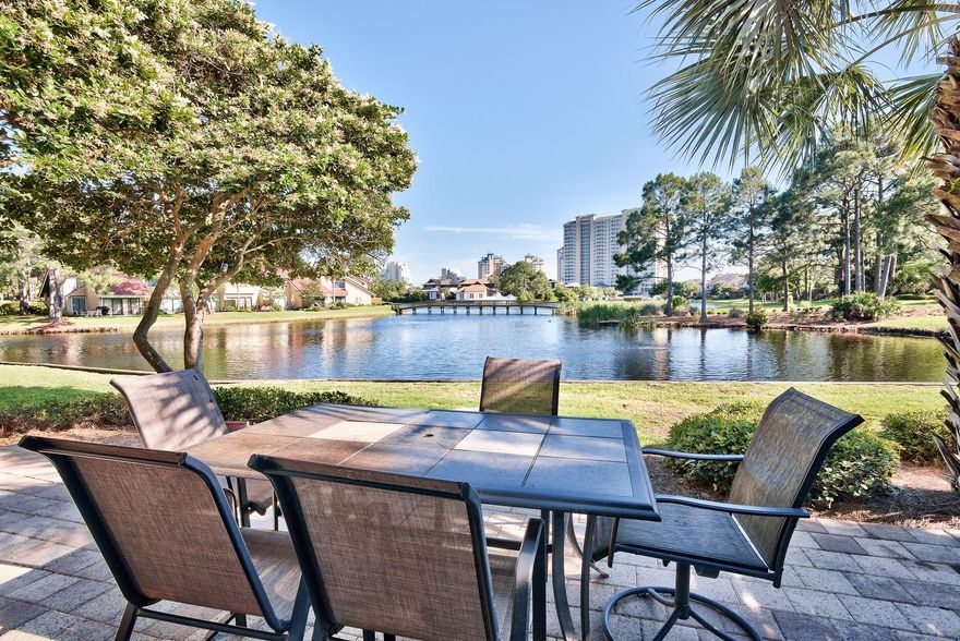 The private lakefront patio of this end unit villa at Beachwalk in the Sandestin Golf and Beach Resort has a wonderful southern exposure location that captures a picturesque water view that includes a pedestrian bridge and fountain beyond. The living room features a vaulted ceiling that allows the space to be filled with light streaming in through sliding glass doors from the patio. Excellent rental income via VRBO by owner is $41,308 for 2014 and $40,775 for 2013. The convenient first floor bedroom enjoys its own private patio. Upstairs, a large loft accommodates two twin beds with room to spare. The adjacent master bedroom capably hosts two queen-size beds. Beautiful tile floors carry throughout living, dining & kitchen with solid surface counters.
