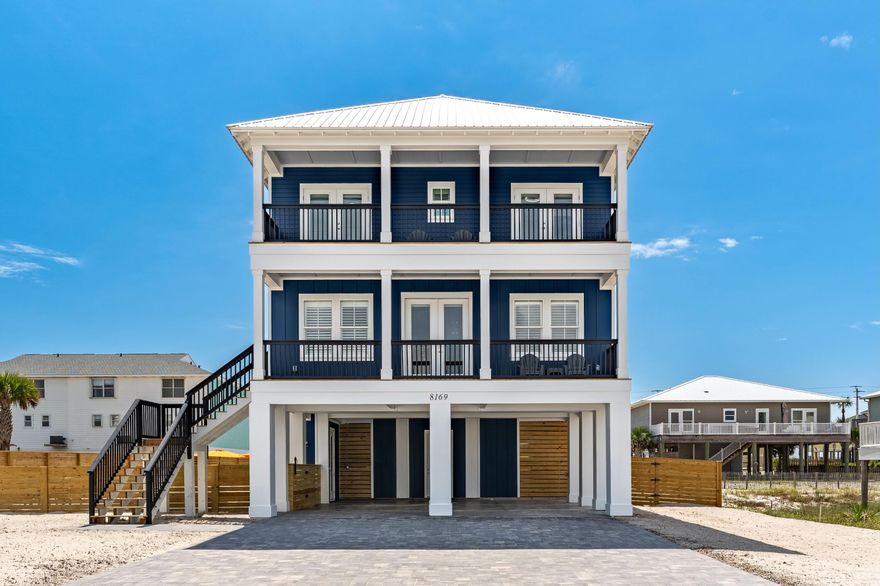 Welcome to 8169 White Sands Boulevard--an exceptional new construction just moments away from the beach. This meticulously designed residence includes thoughtful design extras such as ambient under-counter lighting, plantation shutters, an elevator servicing all three levels and blown glass fixtures. Stunning gulf and canal views are readily available from each level and the home features expansive entertainment spaces across three elegant levels.The main level showcases sophisticated coastal living with 10-foot ceilings, a gourmet kitchen featuring a waterfall island, 36-inch range, built-in ice maker, picture window with gulf views, full-size refrigerator and freezer and a designer counter-to-ceiling tile backsplash. A custom wet bar with beverage refrigerator serves the open-concept living and dining areas. The first master bedroom includes a spacious standalone shower, soaking tub and double vanity, while the second king bedroom features a large tile shower.

The third floor presents a spacious den with a large sectional sofa, a second custom wet bar, and four additional bedroom suites. Three king bedrooms, including a second master, plus a thoughtfully designed bunk room with a custom built bunk that sleeps 6. Each bedroom opens onto a covered deck offering gulf or canal vistas.

Guests are sure to enjoy the outdoor living provided from the second & third level covered decks, a private pool, hot tub, and an expansive covered entertainment area.  Ample parking includes two large covered spaces to keep your vehicle or golf cart out of the elements.

Experience the pinnacle of beach living at "Florida's Most Relaxing Place"Navarre Beach. Schedule Your Private Tour of 8169 White Sands Boulevard Today. 