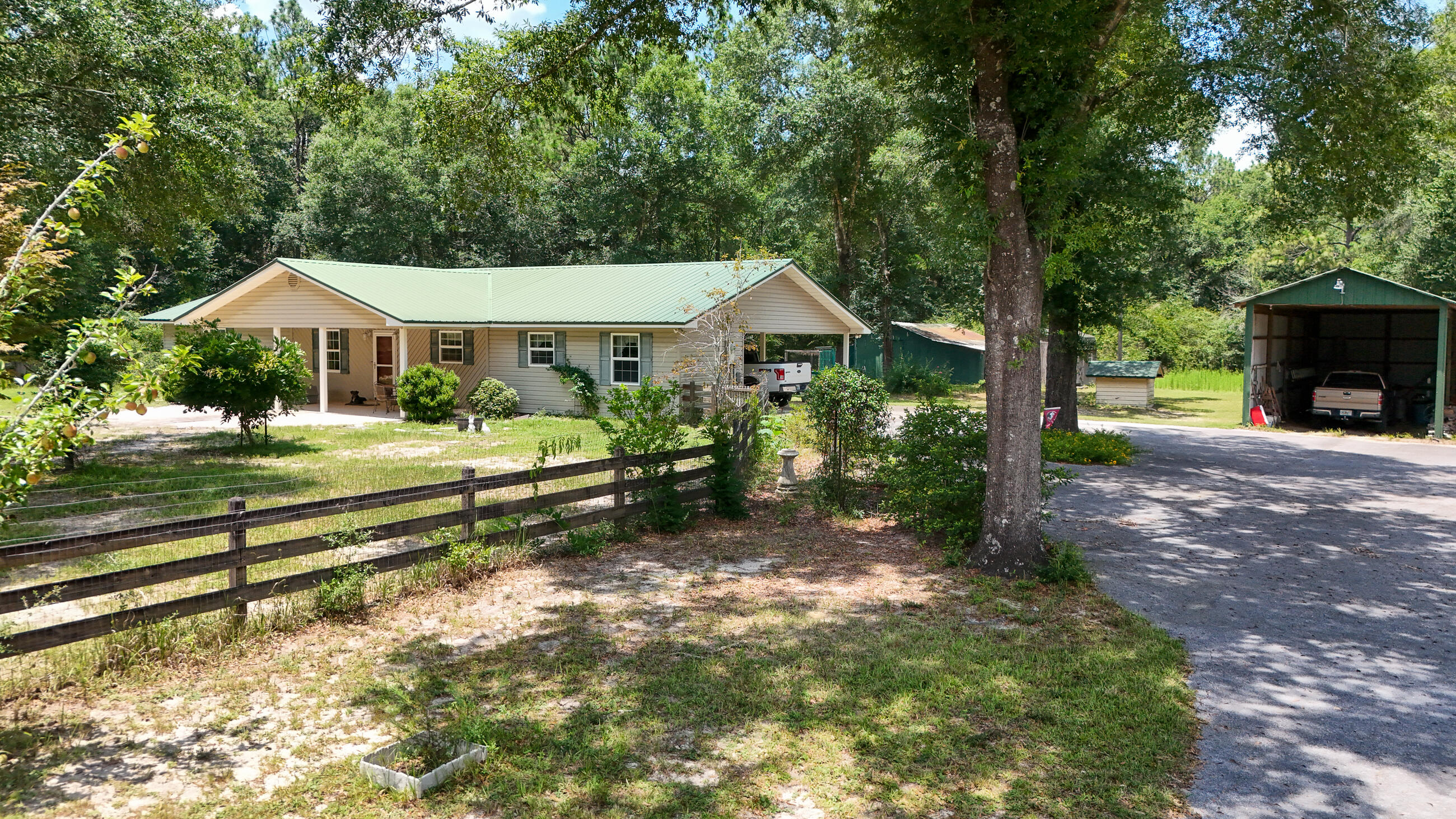 Well-maintained 3-bedroom, 2-bath home sits on 5 peaceful acres just outside city limits, offering room to breathe and space to grow. Inside, you'll find durable tile and luxury vinyl plank flooring throughout. The spacious family room features a wood-burning fireplace with insert--perfect for cozy evenings. The mudroom, measuring 21 by 9.5 feet, provides additional storage or pantry space. Kitchen and bathrooms include quartz countertops for a modern touch. Outdoor enthusiasts will appreciate a 30x42 barn with 50-amp hookup for RVs, plus designated boat storage and second barn with attached chicken coop. HVAC replaced 10/24 and septic drains replaced in 2023. Home also features two water heaters - 40 gal and smaller 12 gal for kitchen. The fruit trees are an added bonus! Don't miss out HVAC is less than a year old and septic drains replaced in 2023. Home also features two water heaters - 40 gallon and a smaller 12 gallon for kitchen. Property boast 15 blueberry bushes, 2 pear trees, lemon tree, chestnut tree and a grapevine. Malloy Lane is a private road with deeded access. Don't miss out.