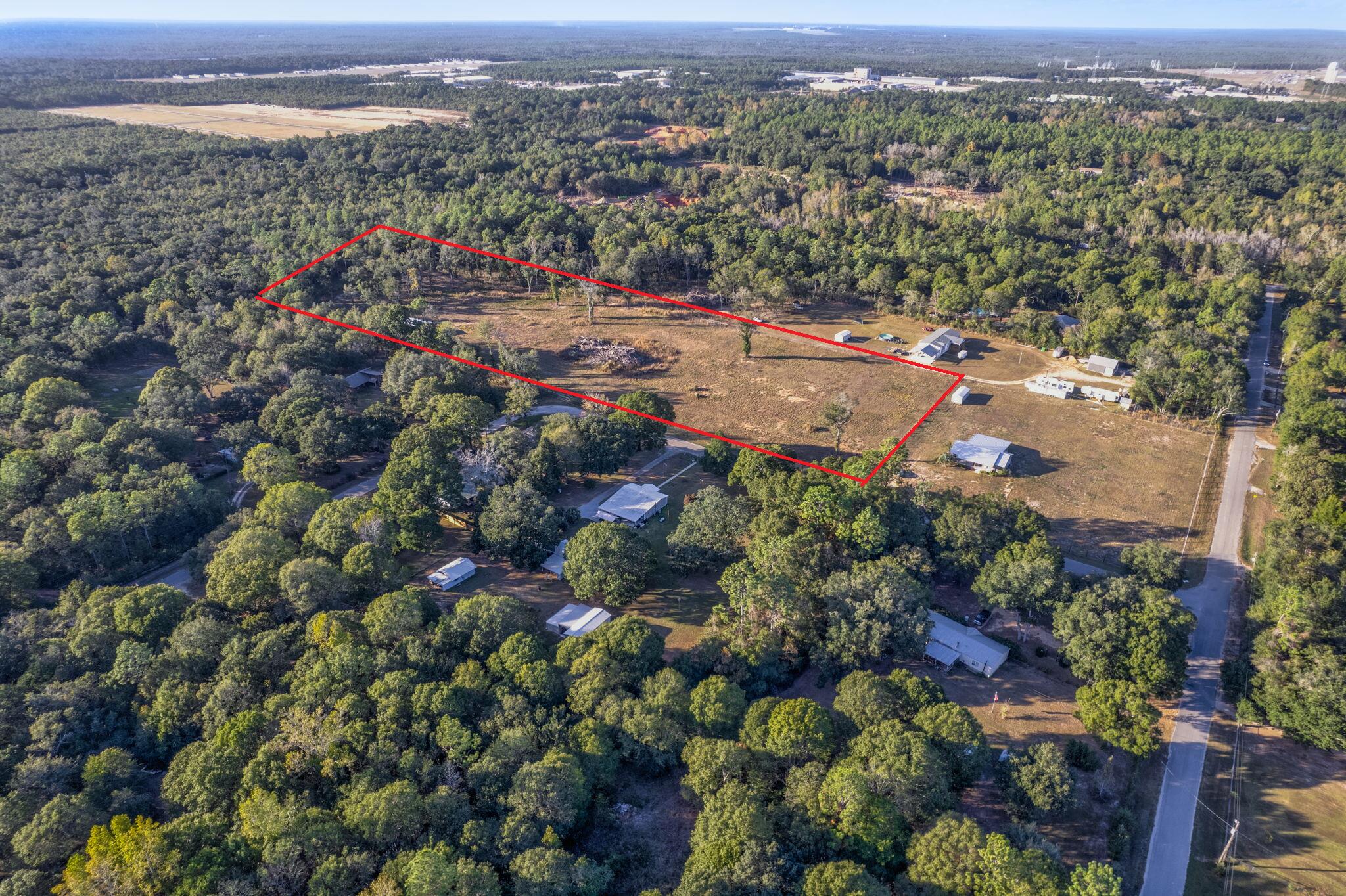 Over 7 acres of cleared, FULLY FENCED land offers an exceptional opportunity for development in a prime location near the intersection of I-10 and Highway 87 in Milton! This property is secured with Industrial-Grade livestock fencing, making it ideal for a variety of agricultural uses or any animals requiring secure enclosure. Zoned for Agriculture, Rural Residential, and Commercial use, this parcel provides flexibility for builders, developers, or investors looking to capitalize on its potential. The land can be subdivided, opening the door to a range of development options -- from private homesteads to commercial ventures. Enjoy the best of both worlds with easy access to major highways and a peaceful, rural setting. City water is available, making this property ready for immediate devel opment. Whether you're planning to build, invest, or expand, this versatile acreage is a rare find with endless possibilities.