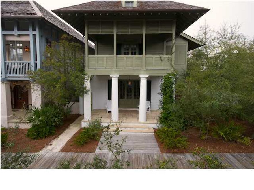 This lovely Rosemary Avenue beach house with attached carriage house is elegant yet casual. Located just steps from the beach with beautiful gulf views from the balcony, the charm of this house is found in the details. The first floor exterior walls are 12'' board-formed concrete, reminiscent of the earliest Florida homes in St. Augustine which is the essence of Rosemary Beach. Once inside you will find stone floors, plaster and bead board walls. The ceilings are bead board throughout and old beams span the first floor open living area which includes living room, dining area, kitchen, pantry and half bath. Ascend the stair steps hewn of reclaimed, antique oak to a gallery-style hallway that gives the impression of being in an enclosed porch.