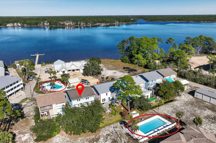 Rare opportunity to own both sides of a beautifully updated duplex in West Panama City Beach with picturesque views of Lake Powell, one of Florida's largest and most pristine coastal dune lakes. Located in the Pirates Cove community, this exceptional property boasts exclusive access to the Gulf via a private dock and boat launch, offering a refined coastal lifestyle ideal for boating, fishing, paddle boarding, and kayaking. Enjoy direct water access from your own backyard, while being just minutes from the sugar-white sands of the Gulf, the boutiques and dining along Scenic Highway 30A, and the natural beauty of Camp Helen State Park.  (149 CAIN ROAD AND 150 CAIN ROAD BEING SOLD TOGETHER PARCEL IDS: 35257-060-000 AND  35257-050-000) Pirates Cove also features two community pools, and the elevated coastal design of this home provides spacious covered parking beneath the home, accommodating multiple vehicles, a boat, and offering flexibility for storage and outdoor gear.
The interiors feature a bright, open-concept layout with a relaxed coastal aesthetic and thoughtful updates throughout. Expansive living and dining areas are filled with natural light, creating an open and inviting space ideal for entertaining. Updated kitchens showcase granite countertops, stainless steel appliances, gray shaker cabinetry, and generous bar seating, seamlessly connecting to the living and dining spaces.

Both units are tastefully updated, turn-key furnished, and supported by a strong rental history, making this an exceptional investment opportunity, multi-family retreat, or private coastal getaway.